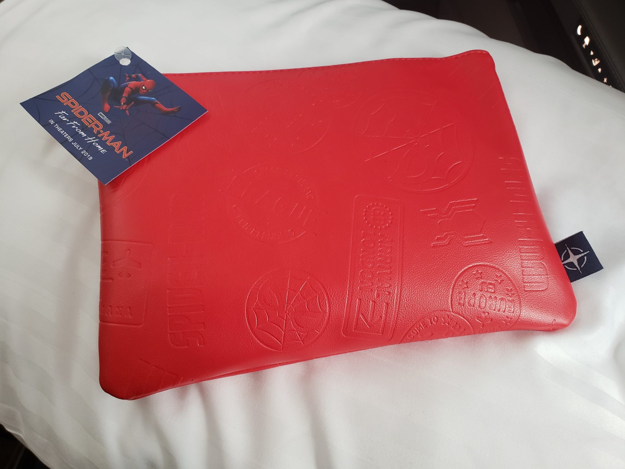 a red pillow with a tag on it
