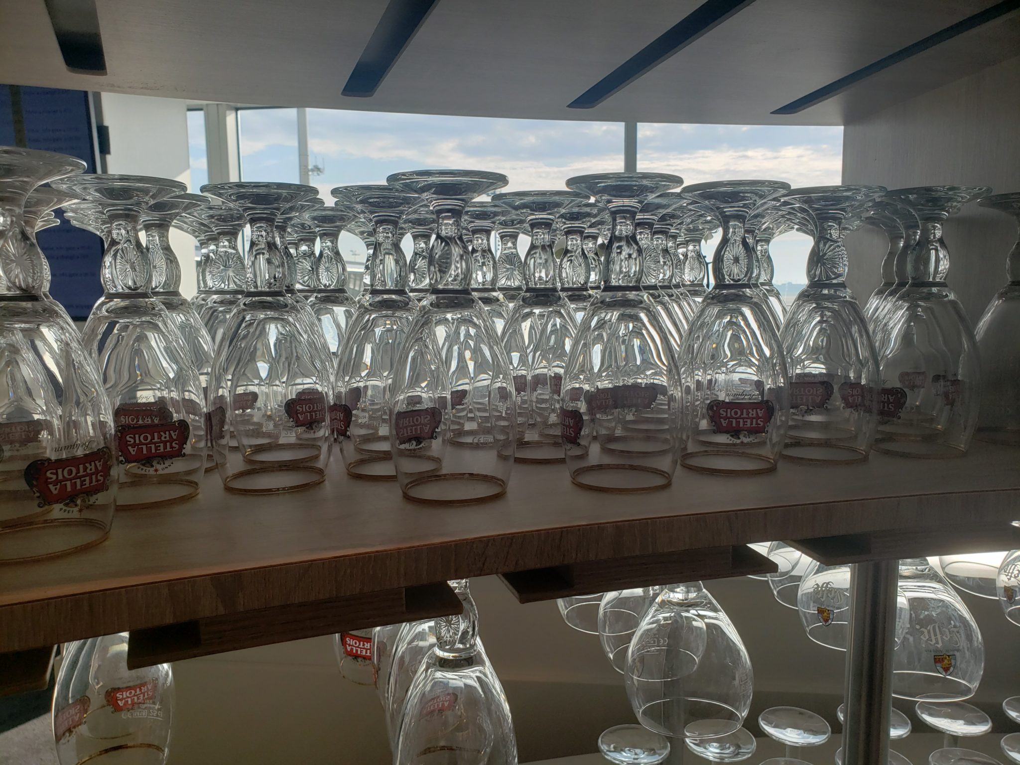 a shelf with many glasses on it