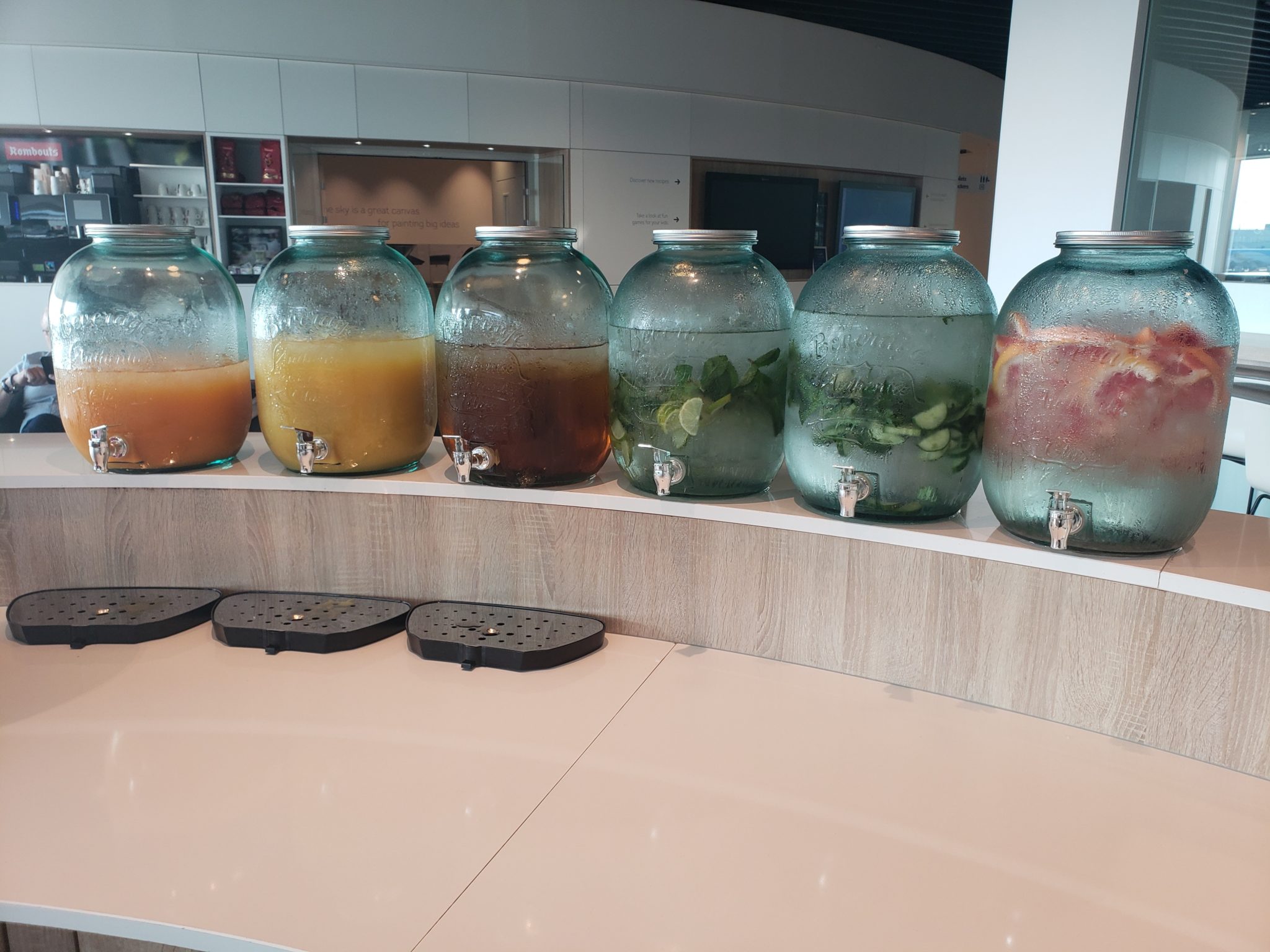 a row of glass jars with different types of liquid in them