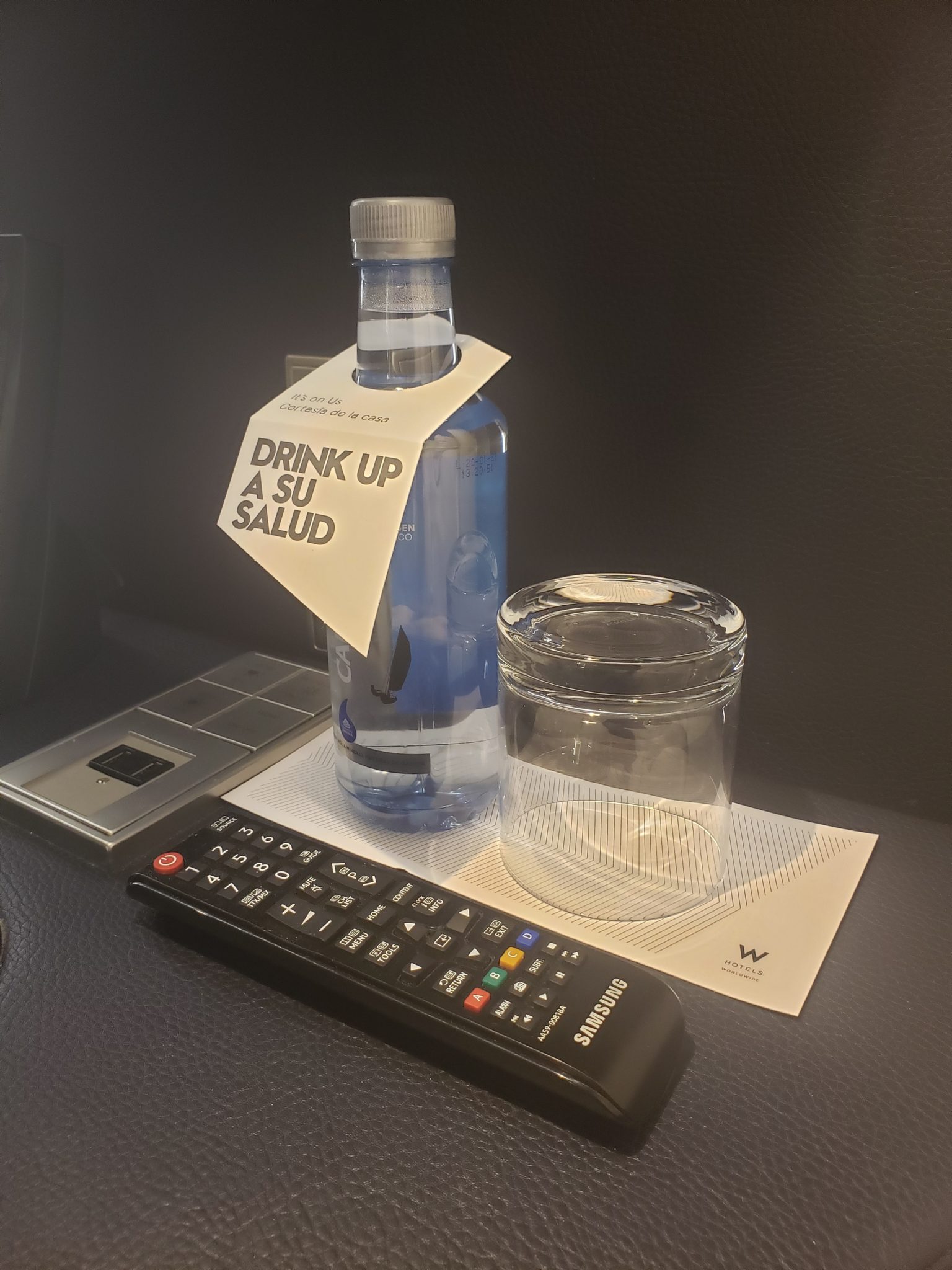 a bottle of water and a glass on a table