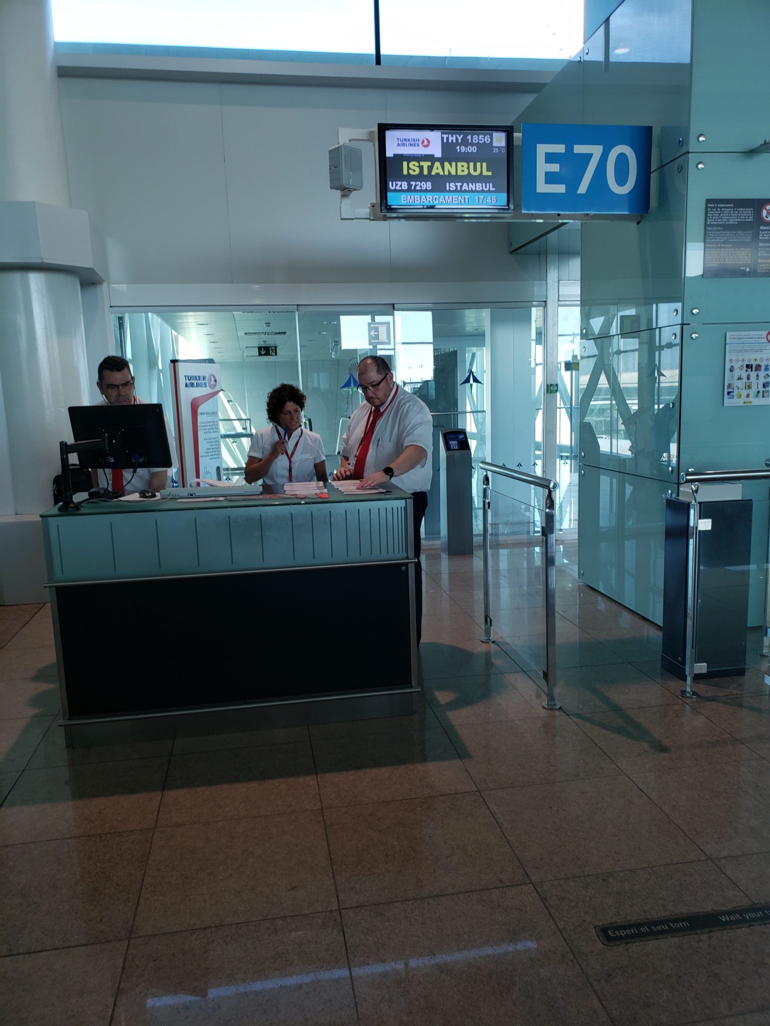 a man and woman at a desk in a airport