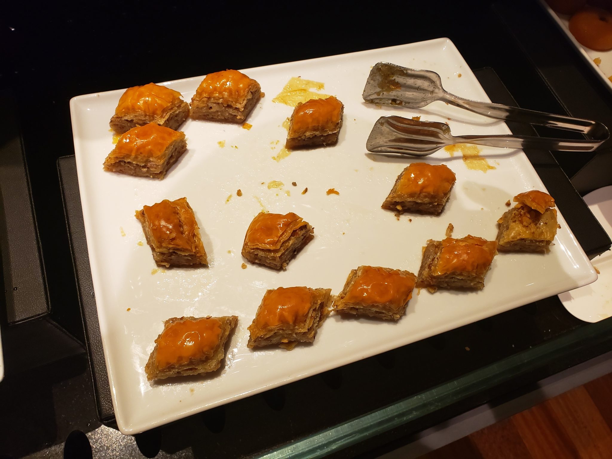 a plate of pastries and tongs