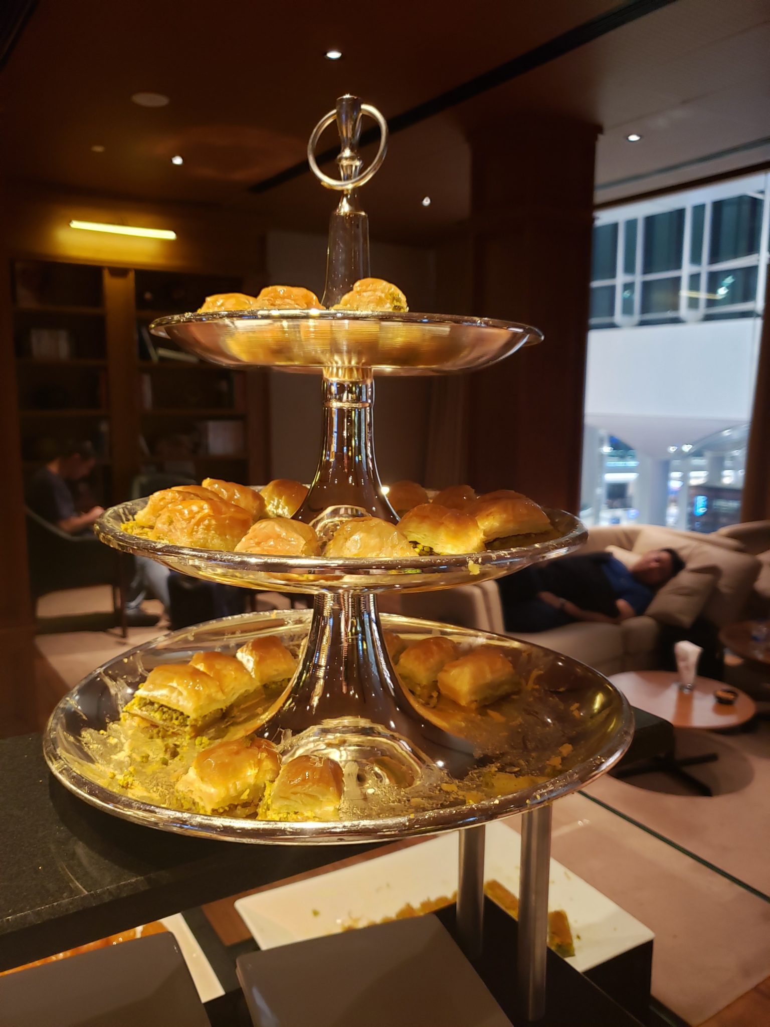 a three tiered tray with pastries on it