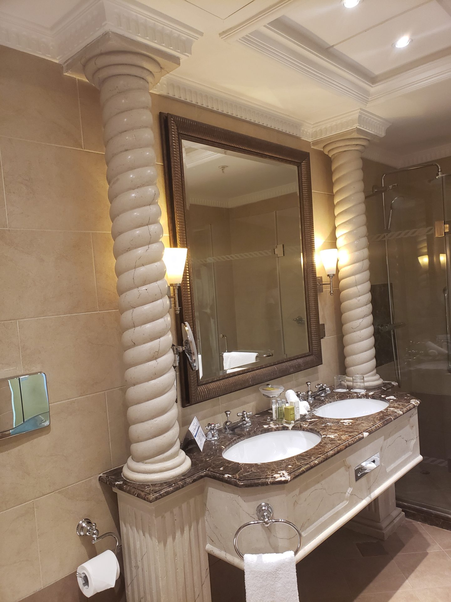 a bathroom with marble counter tops and a mirror