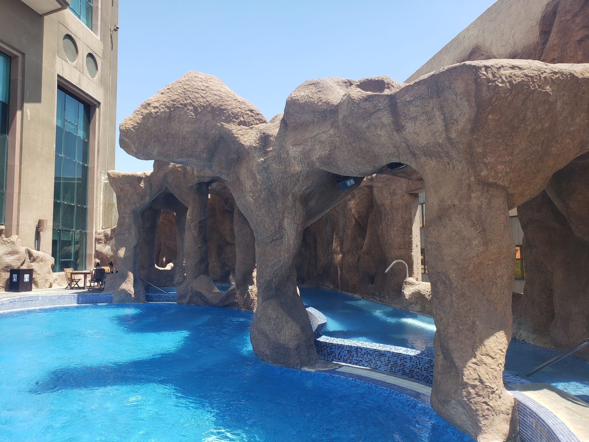 a pool with a large rock structure