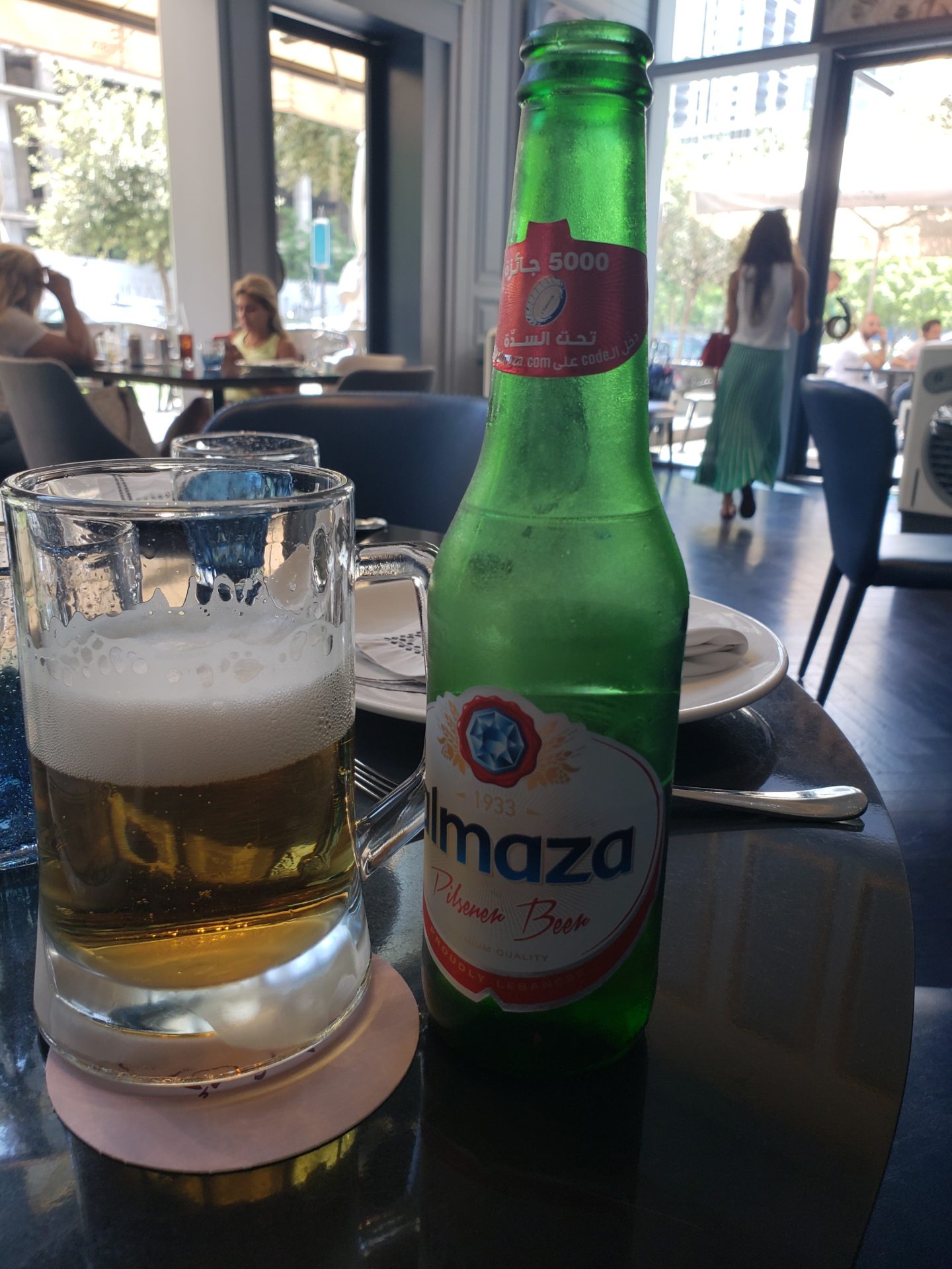 a green bottle and glass of beer on a table