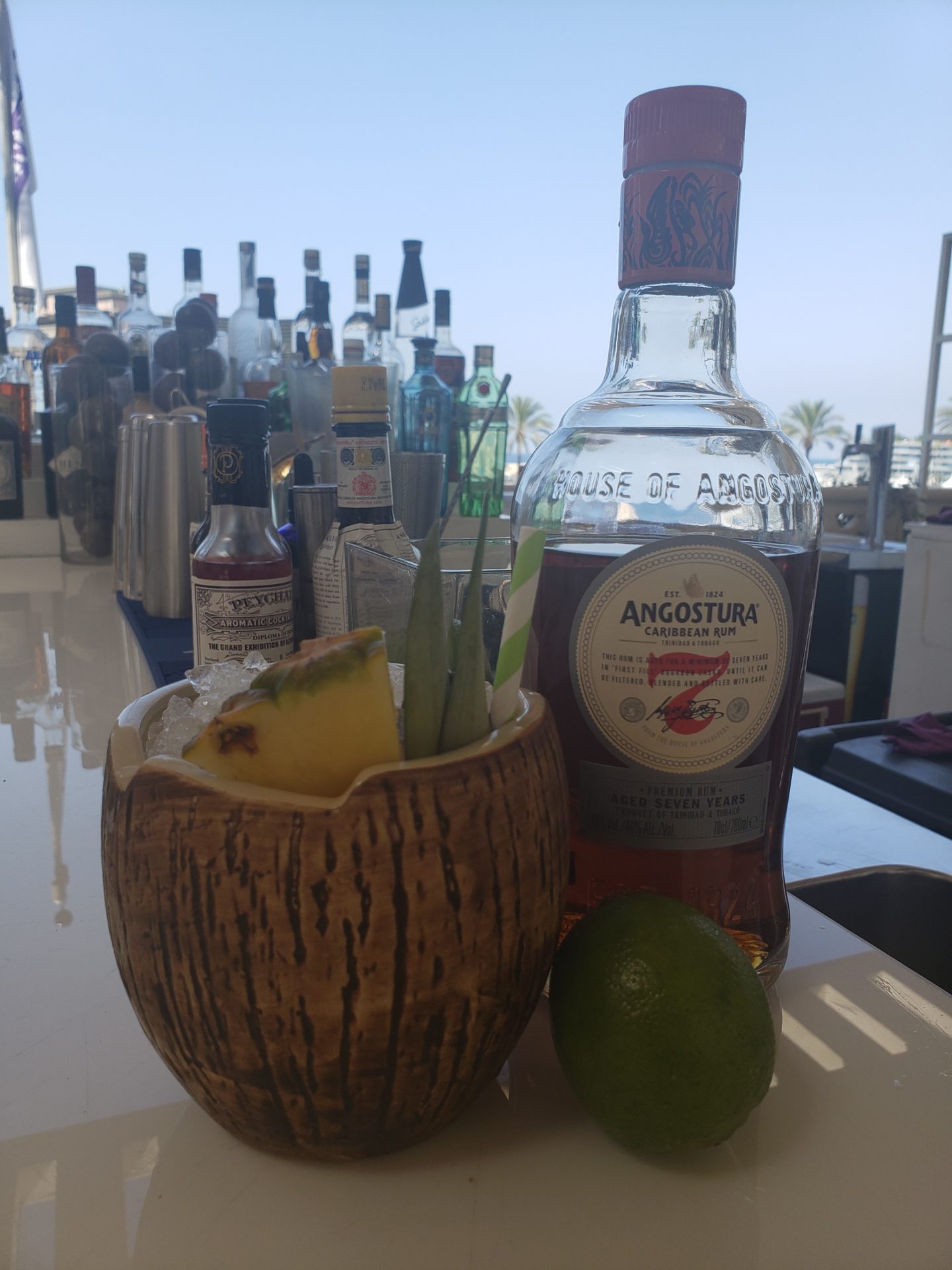 a bottle of alcohol next to a coconut cup