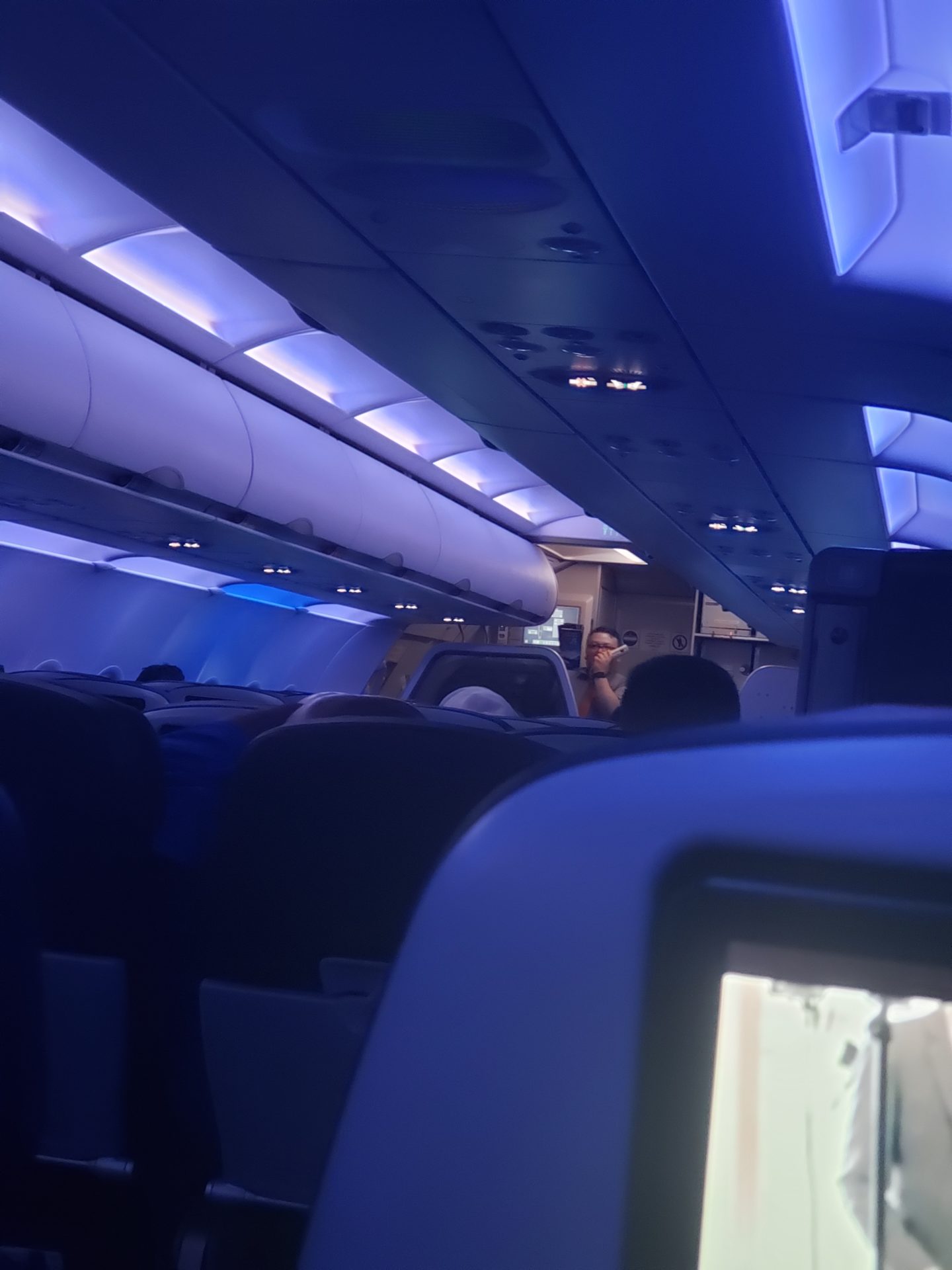 inside an airplane with a man standing in the back