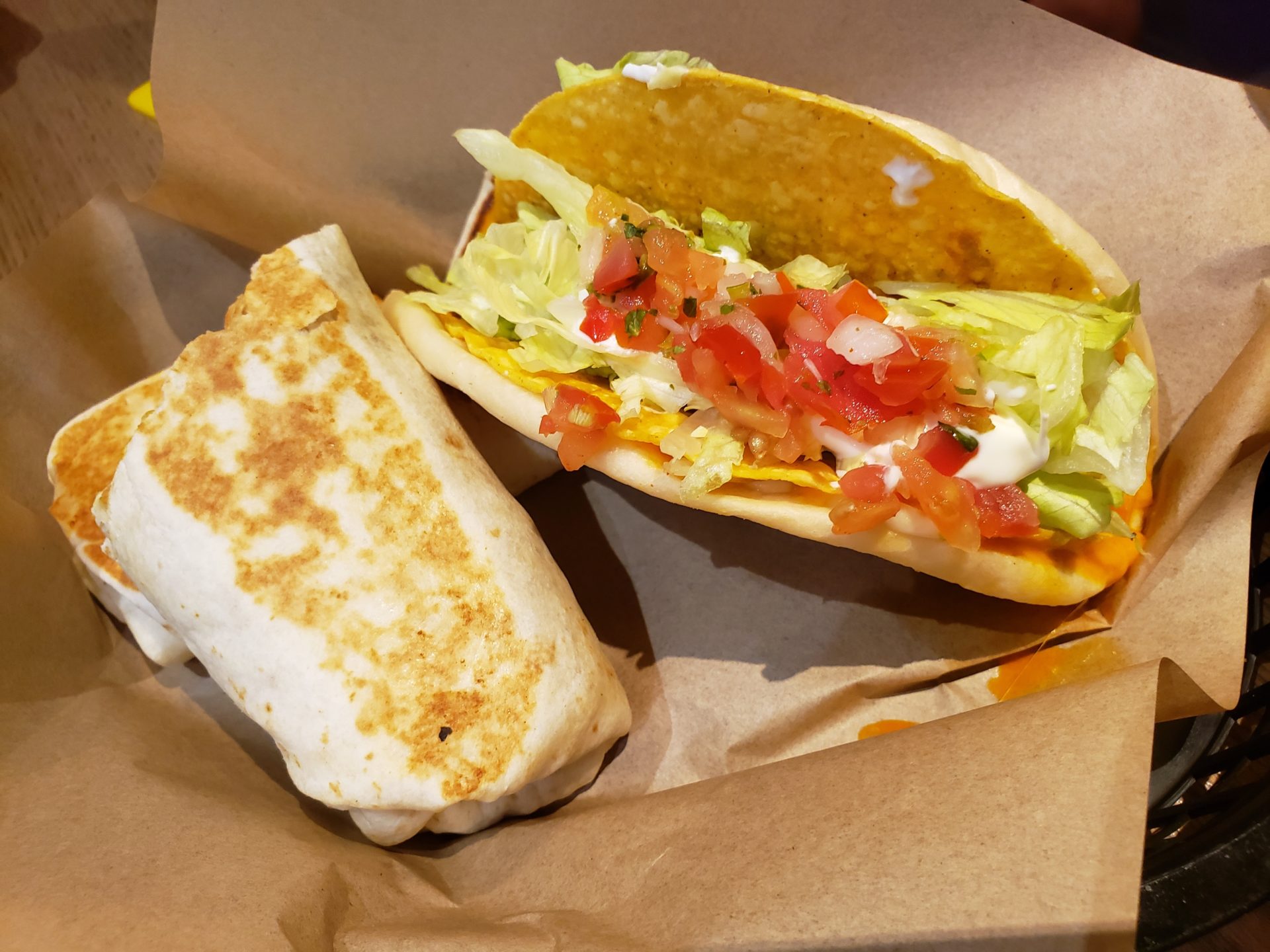 a taco and burrito on a brown paper