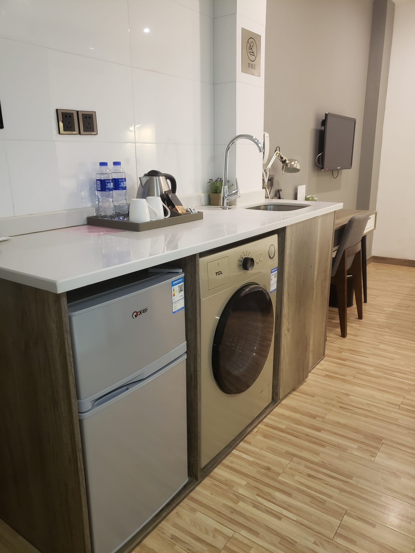 a kitchen with a washing machine and a sink
