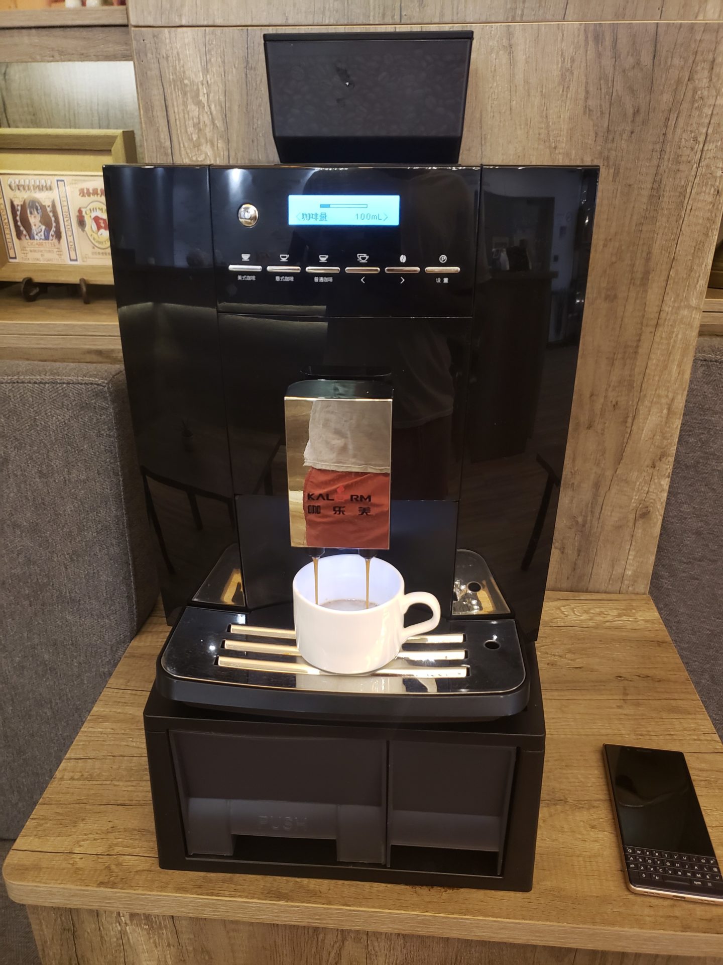 a coffee machine with a cup on top of it