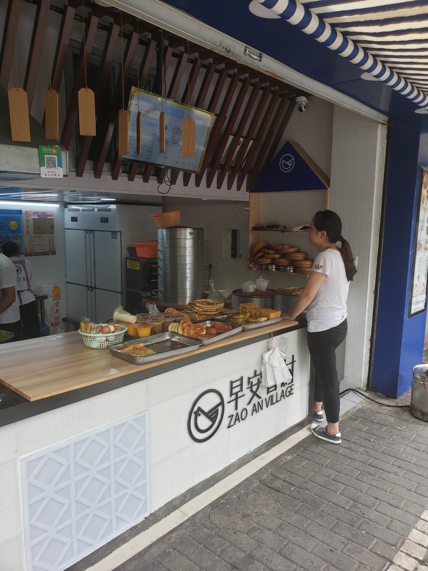 a woman standing at a counter with food on it