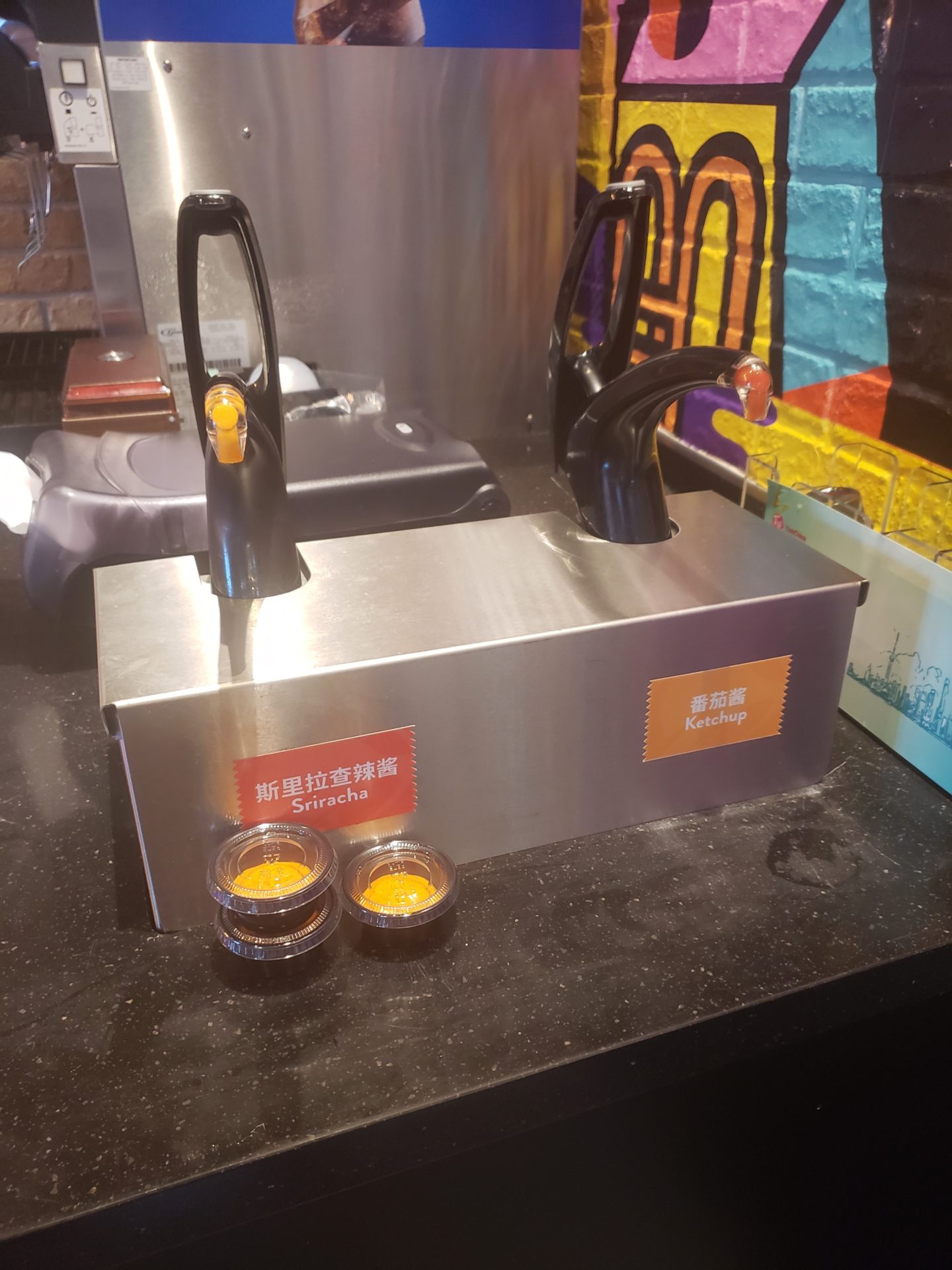 a machine with sauces on a counter