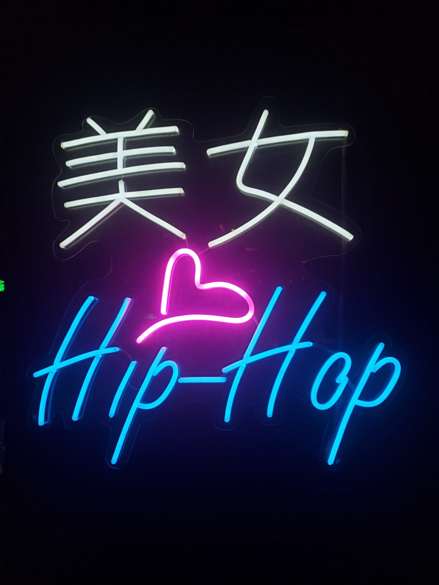 a neon sign with text and a heart