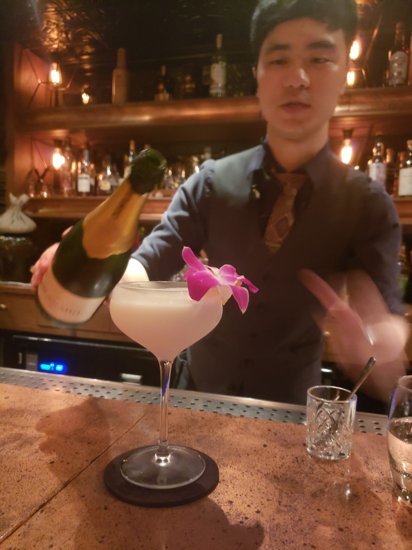 a man pouring a drink into a glass
