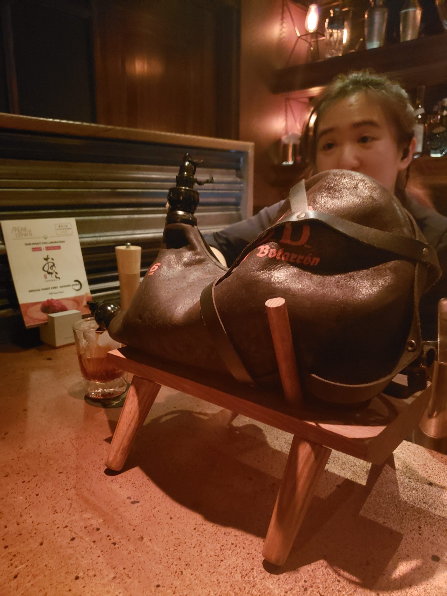 a person sitting at a table with a leather shoe on it
