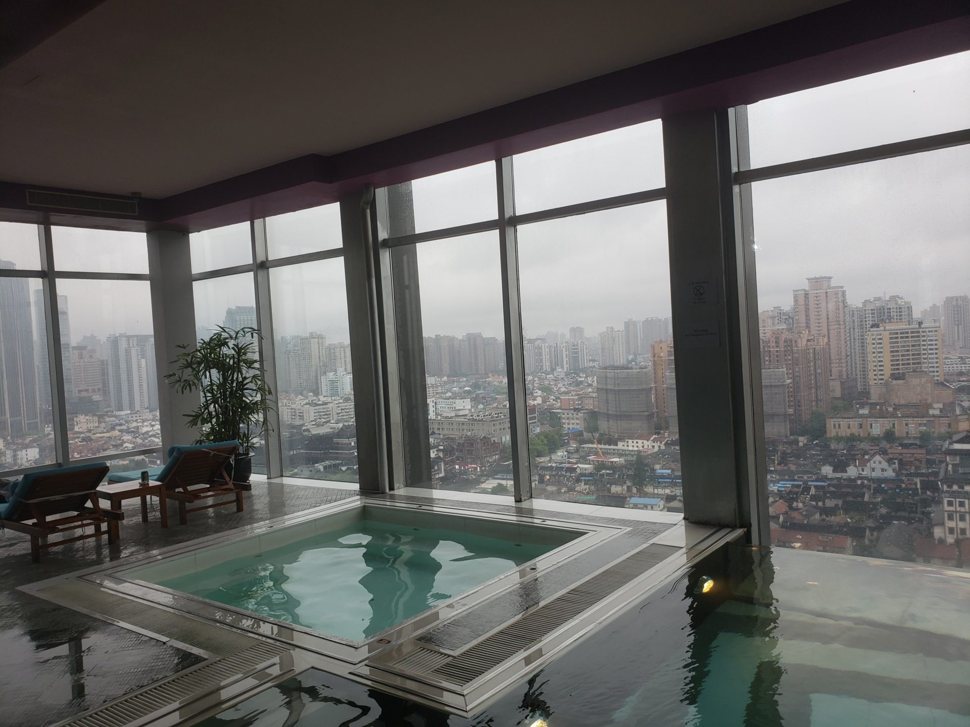 a indoor pool with a view of a city