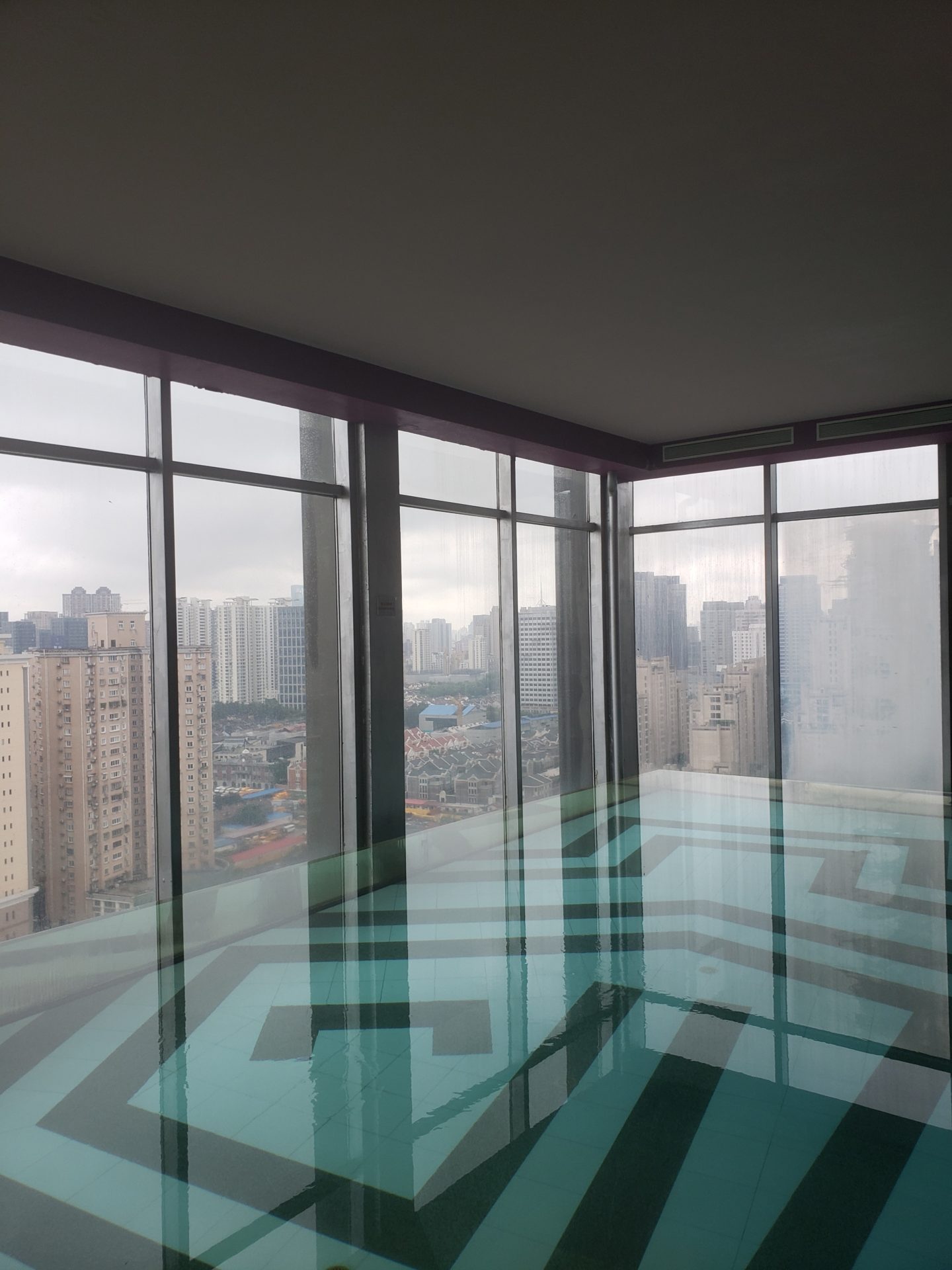 a large glass floor with a view of a city