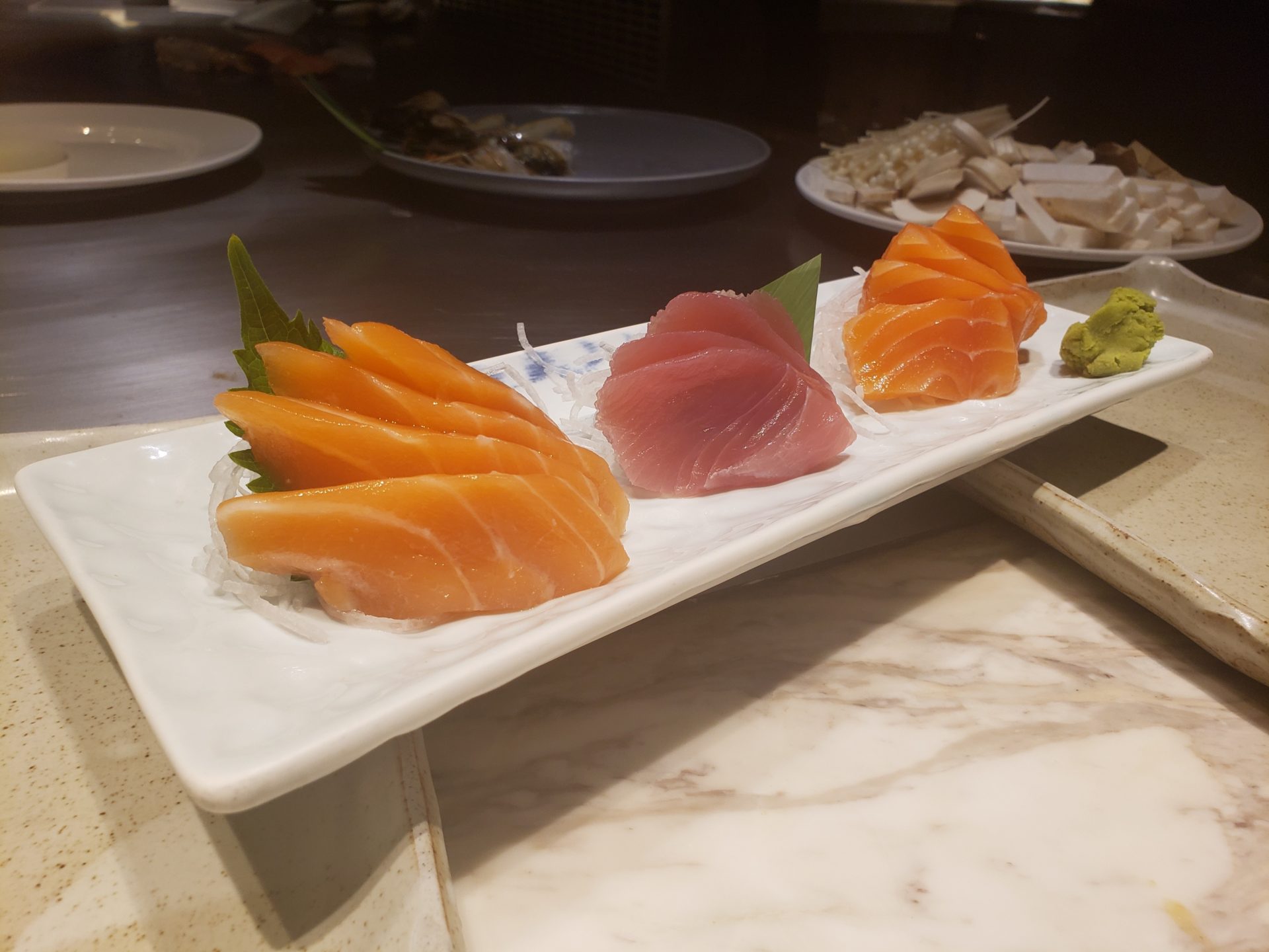 a plate of raw fish on a table