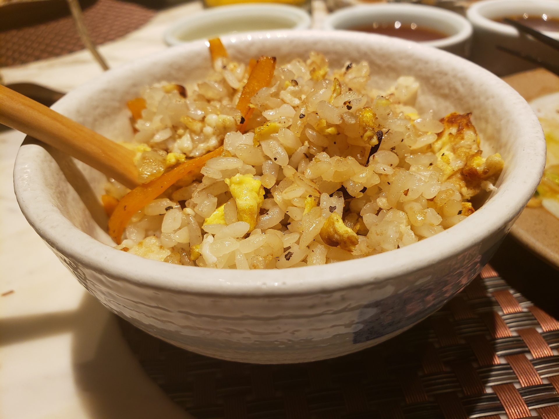 a bowl of rice with chopsticks