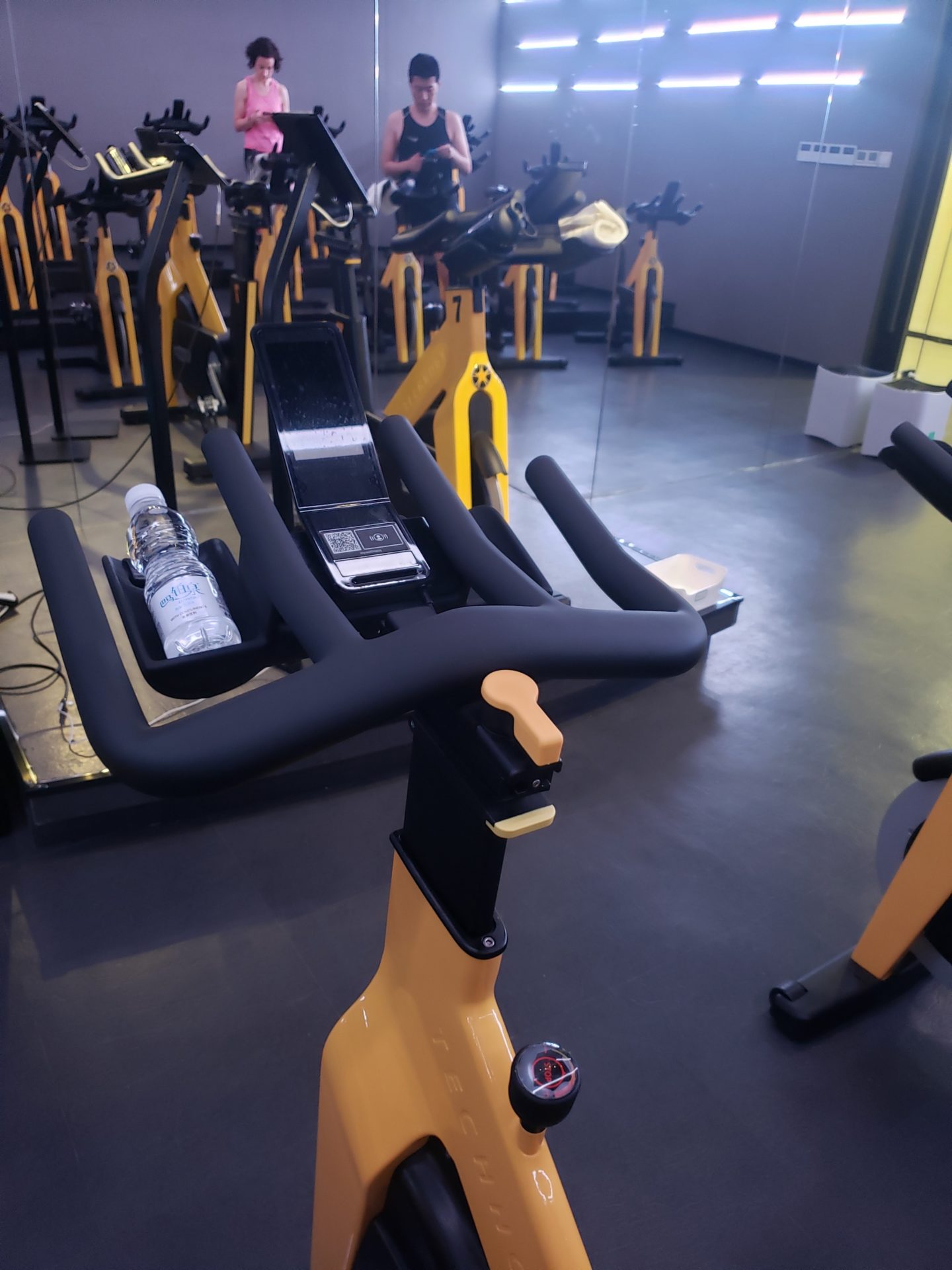 a group of exercise bikes in a gym