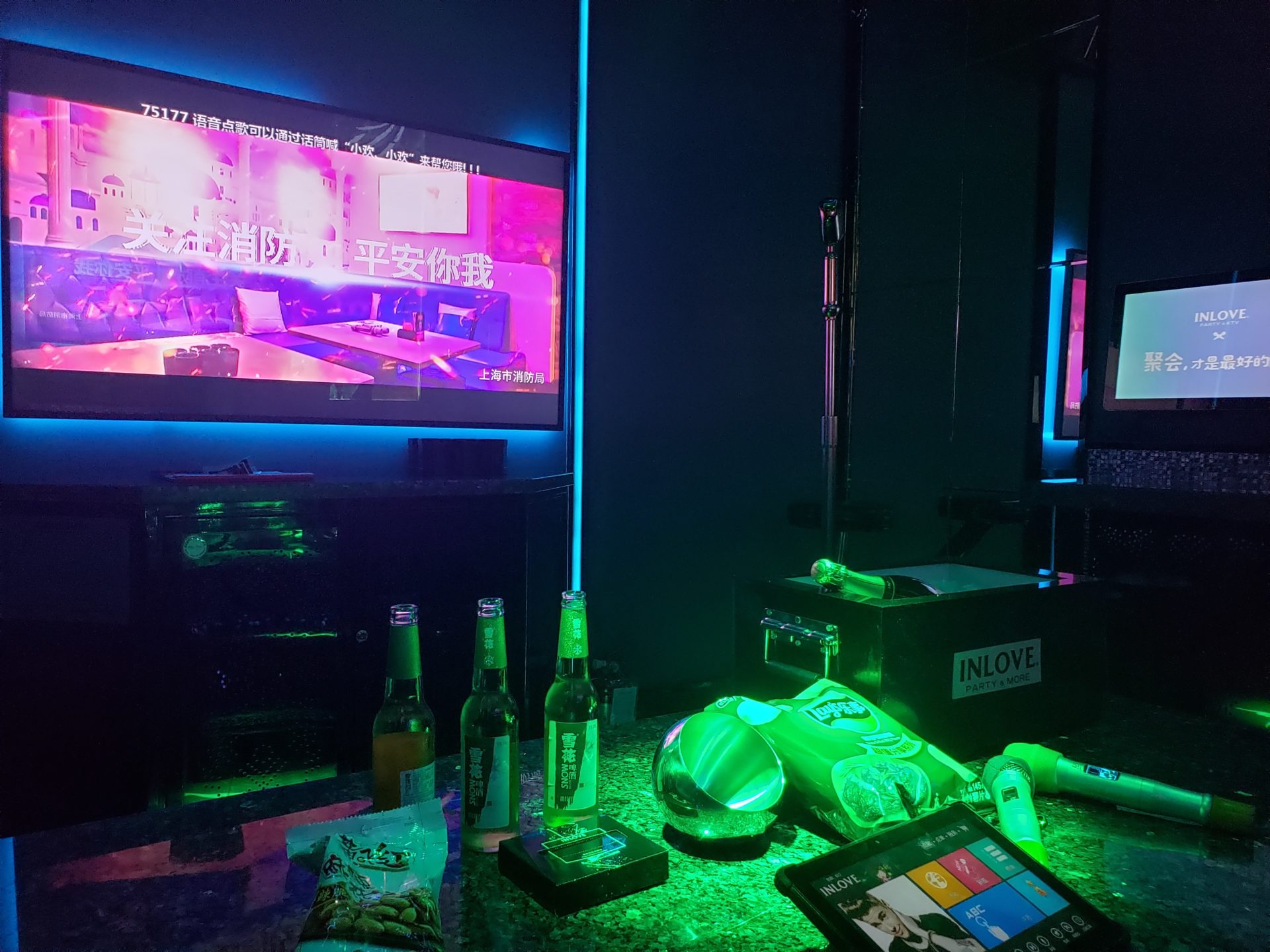 a tv and bottles on a table