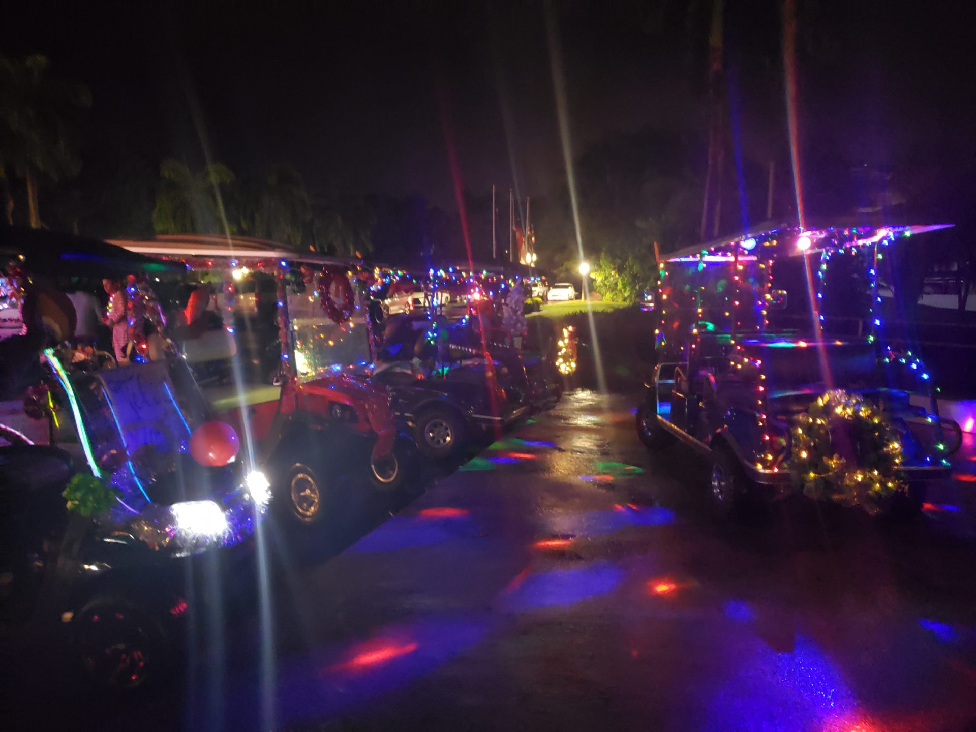 a group of golf carts decorated with lights