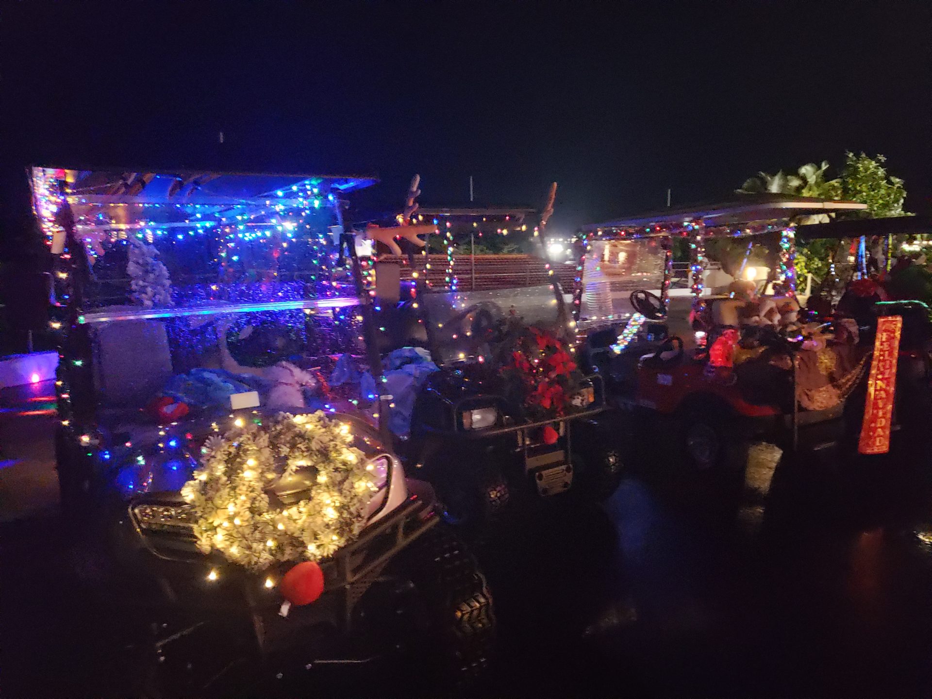 a group of golf carts decorated with lights