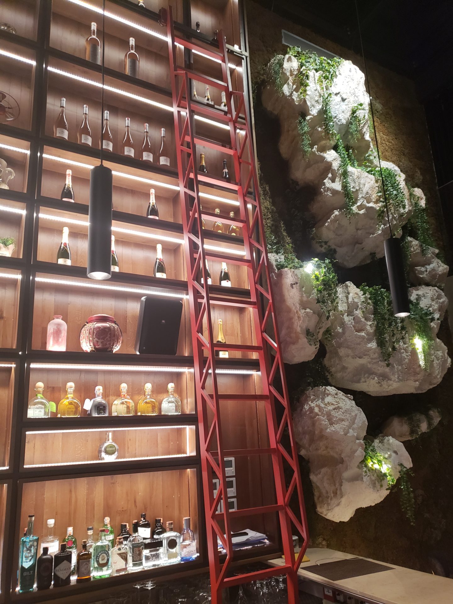 a ladder and shelves with bottles and rocks