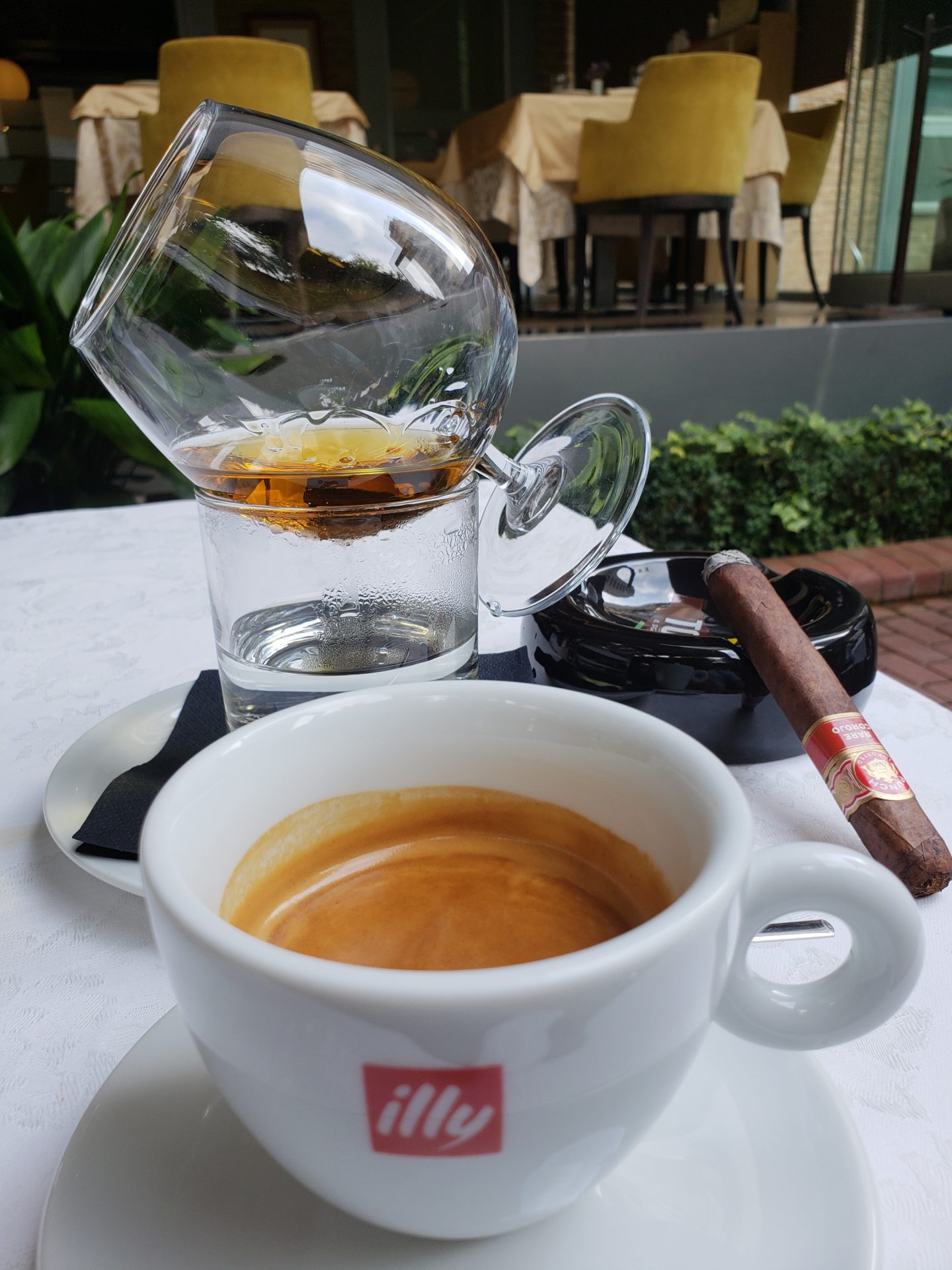 a cup of coffee and a cigar on a table