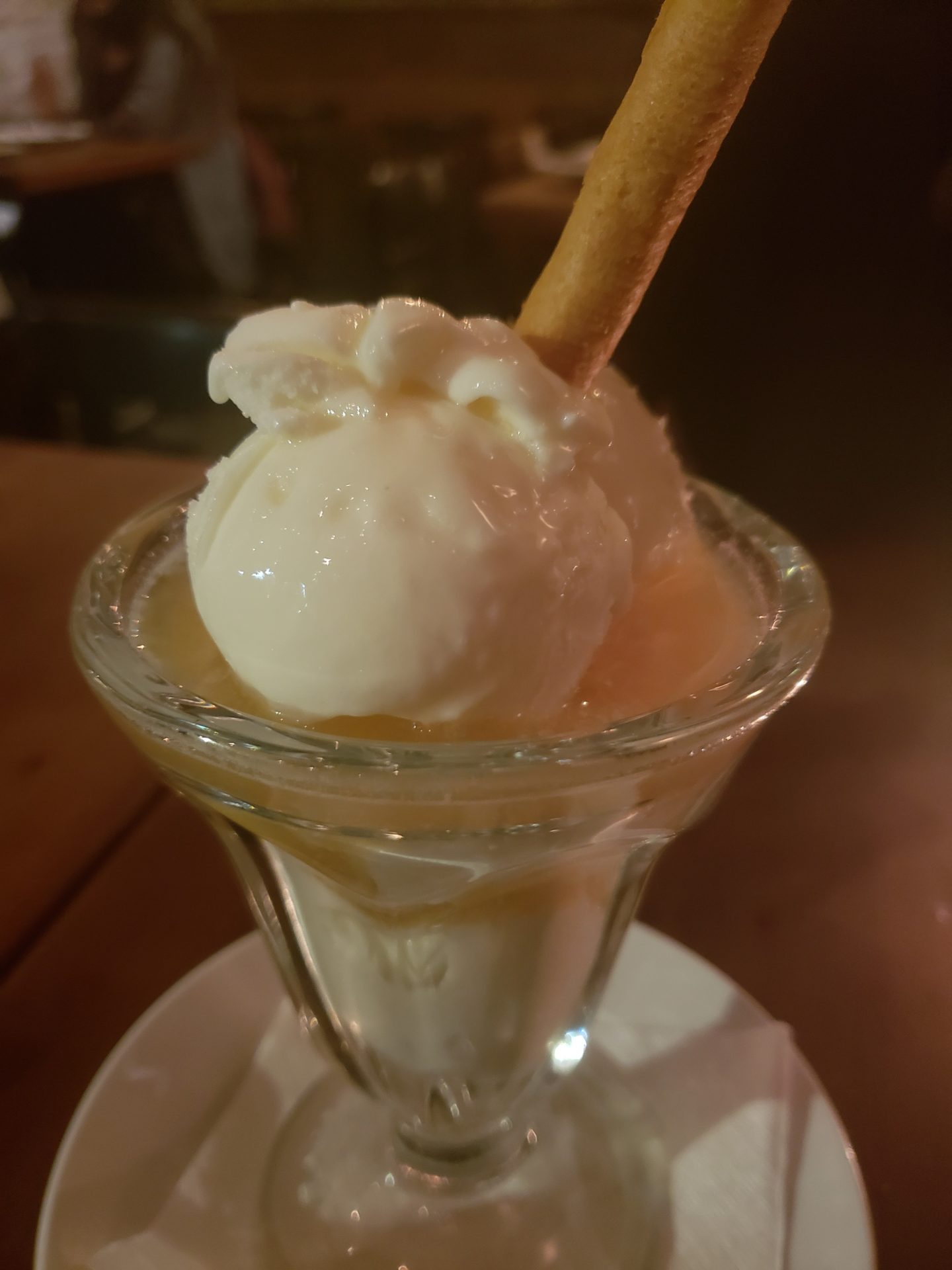 a glass cup with a scoop of ice cream and a cookie on top