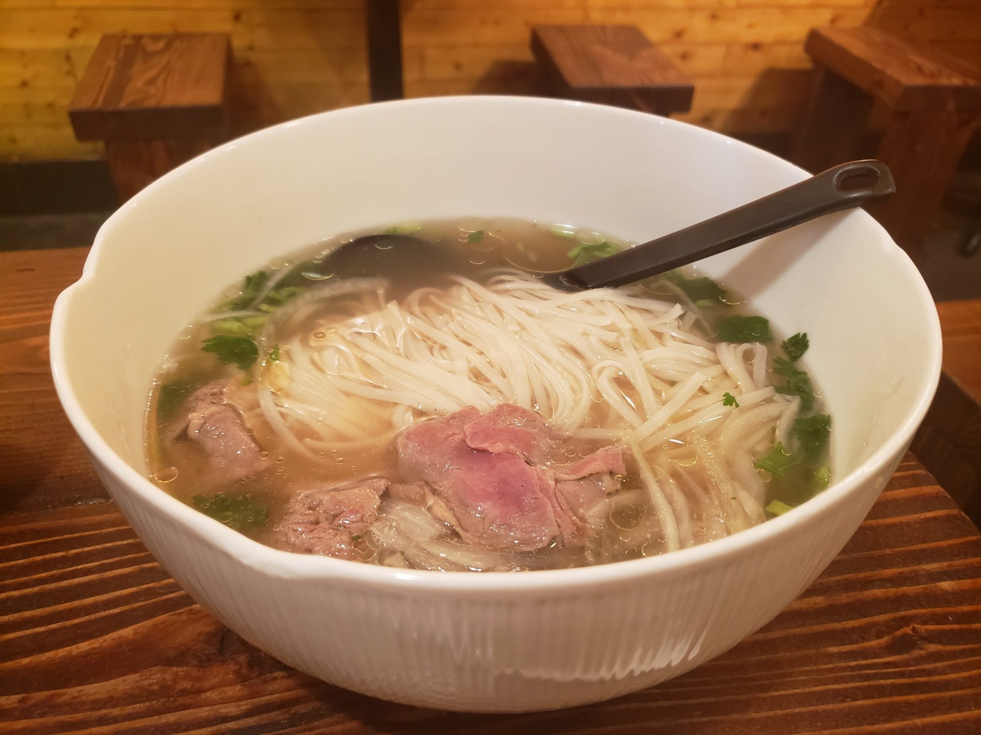 a bowl of soup with meat and noodles