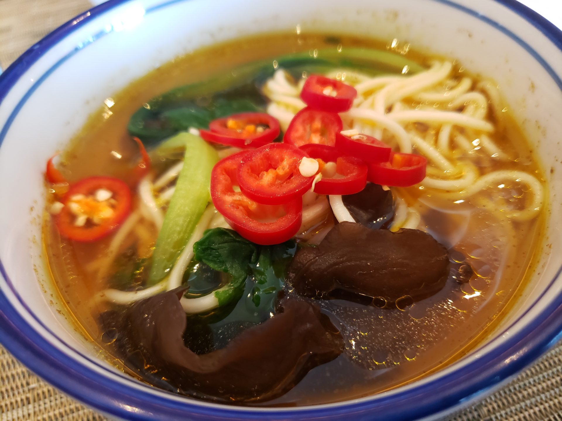 a bowl of soup with noodles and vegetables