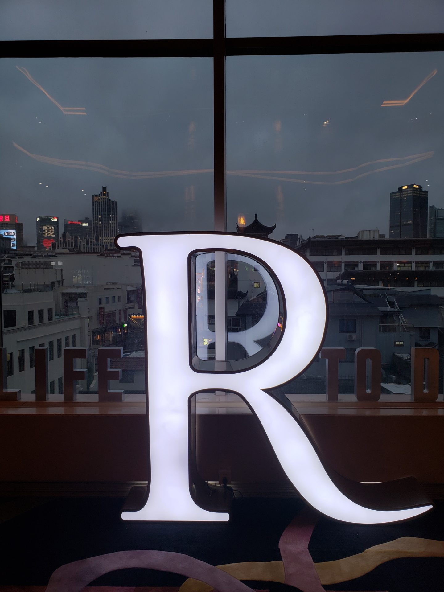 a large white letter on a window