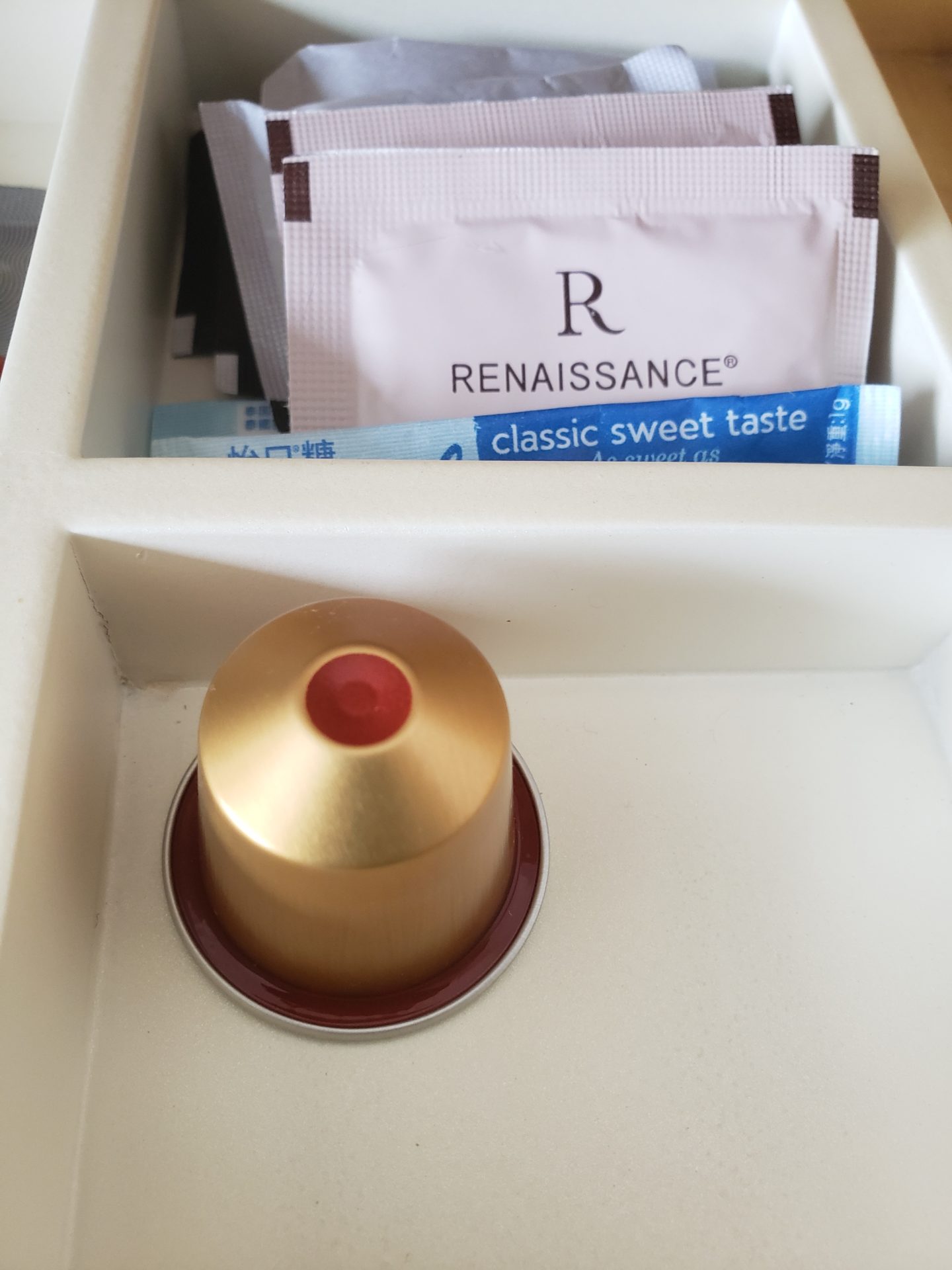 a white container with a gold object in it