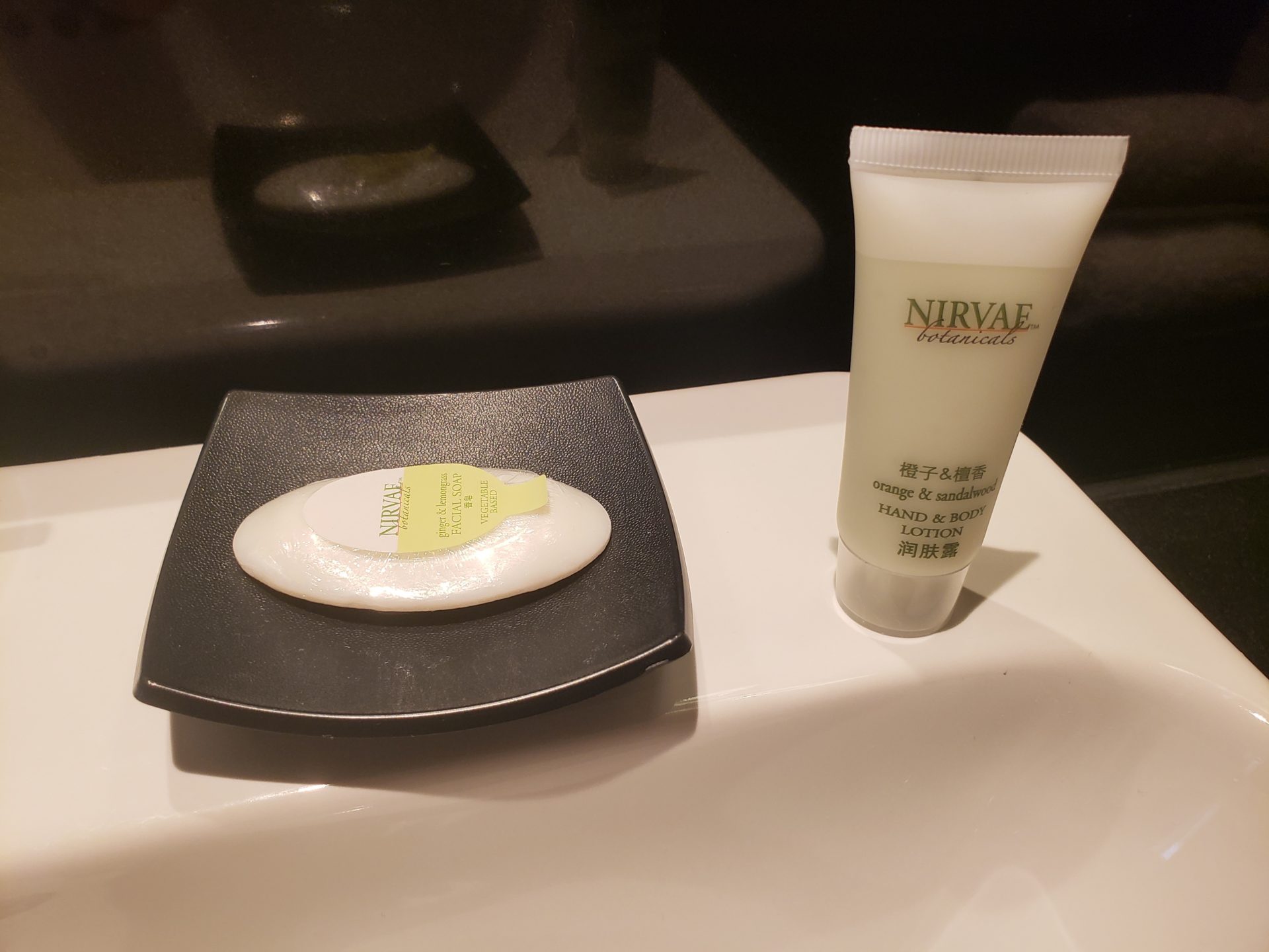 a soap and a tube of cream on a black dish