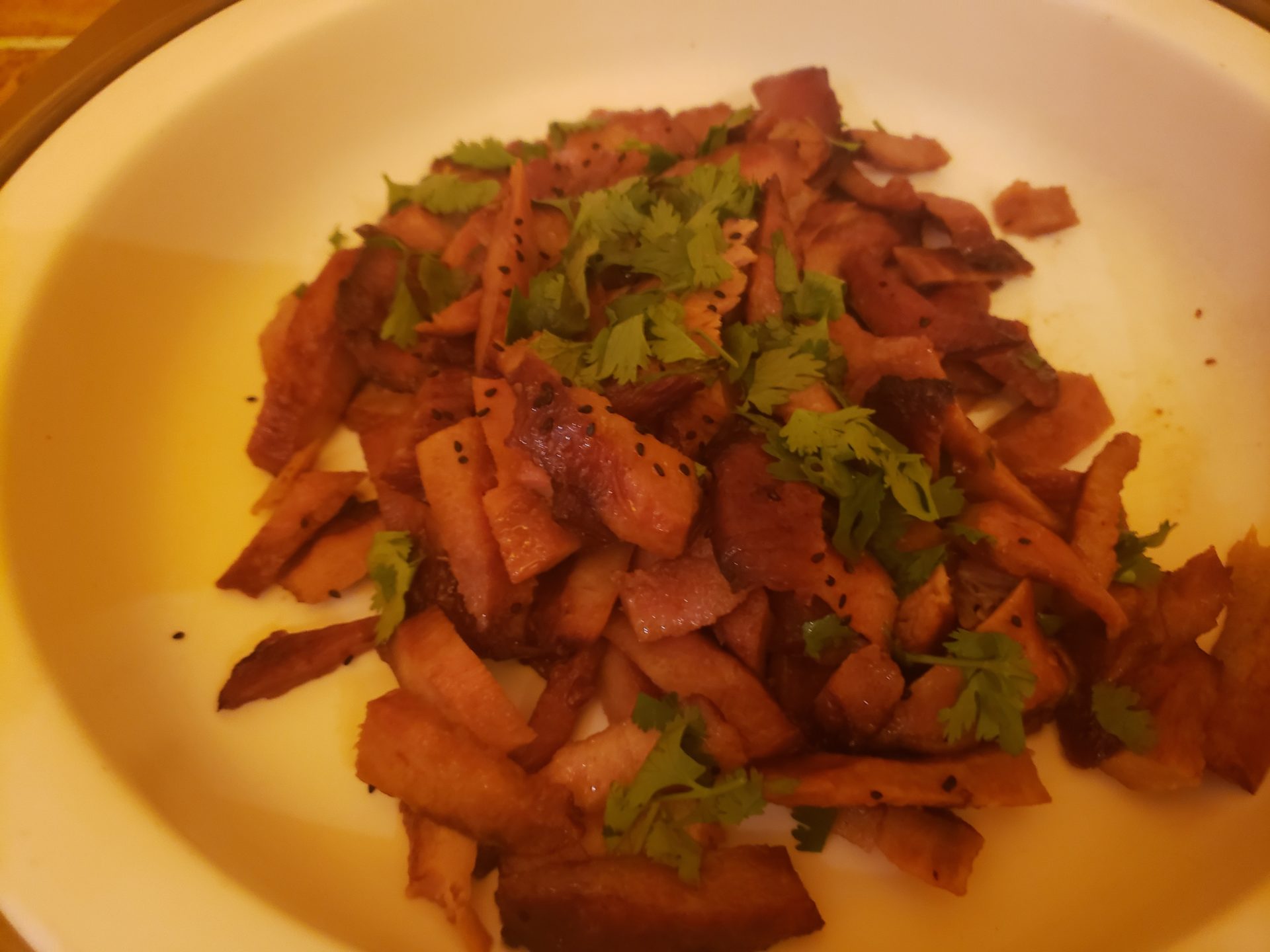 a plate of food with meat and cilantro