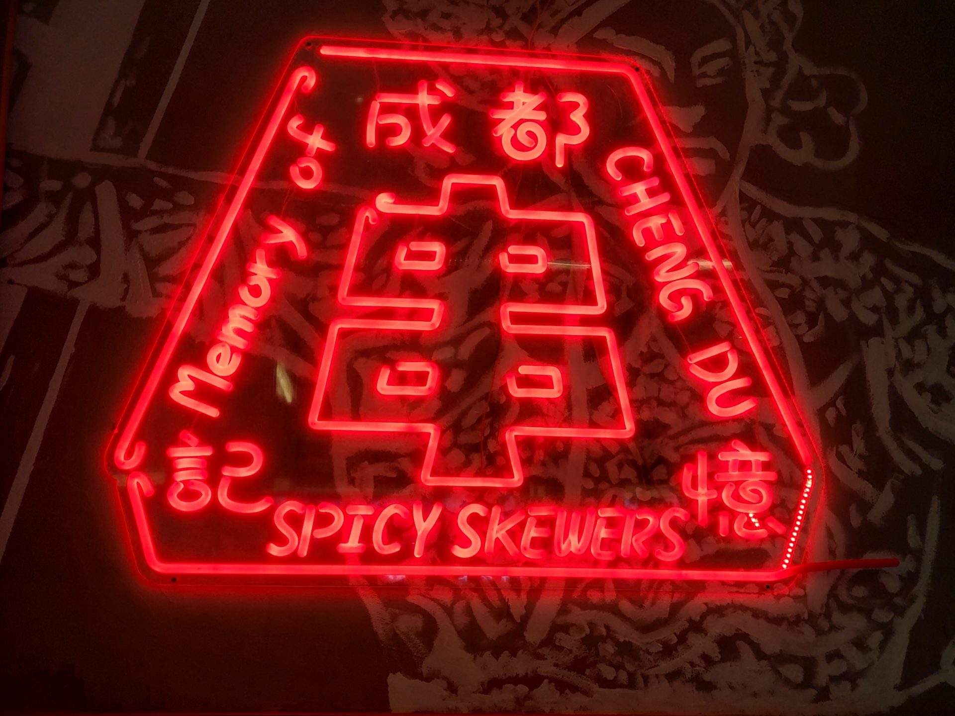 a red neon sign with writing