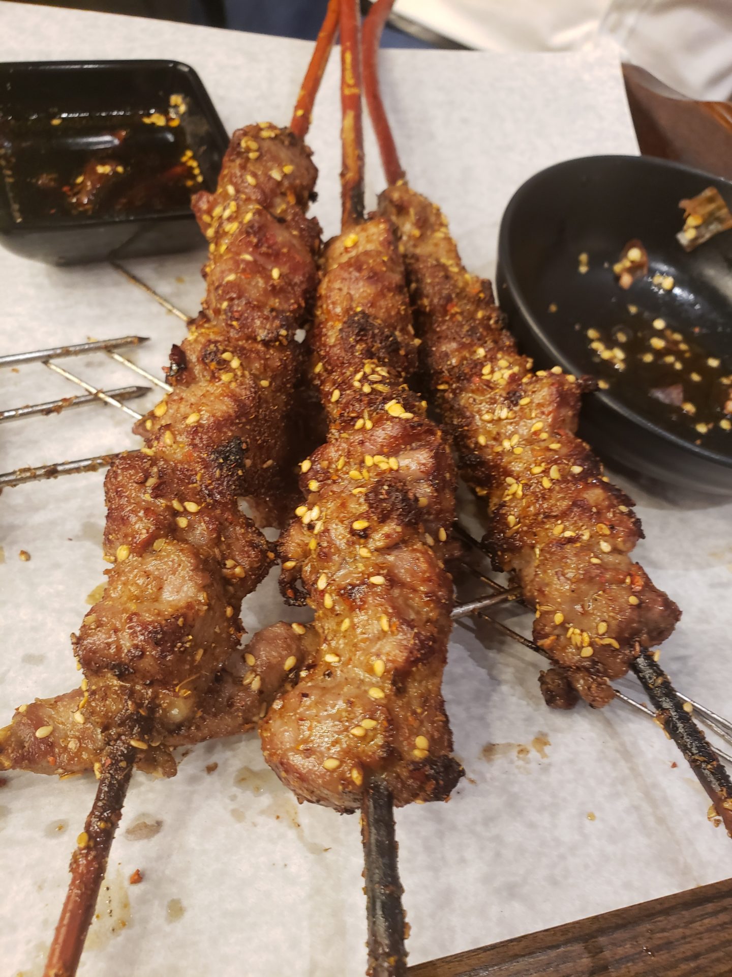 a group of meat on skewers