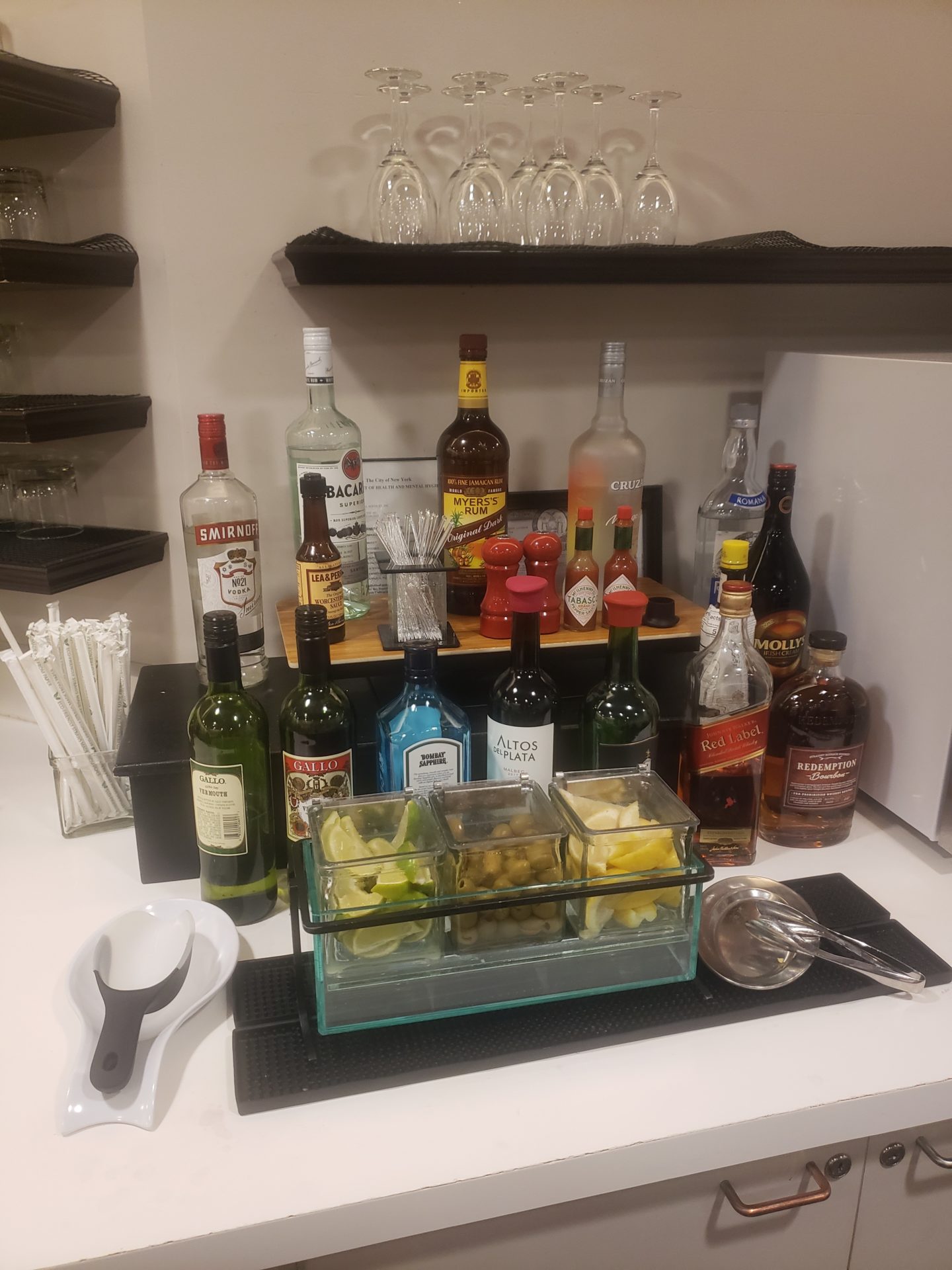 a bar with bottles of alcohol and fruit