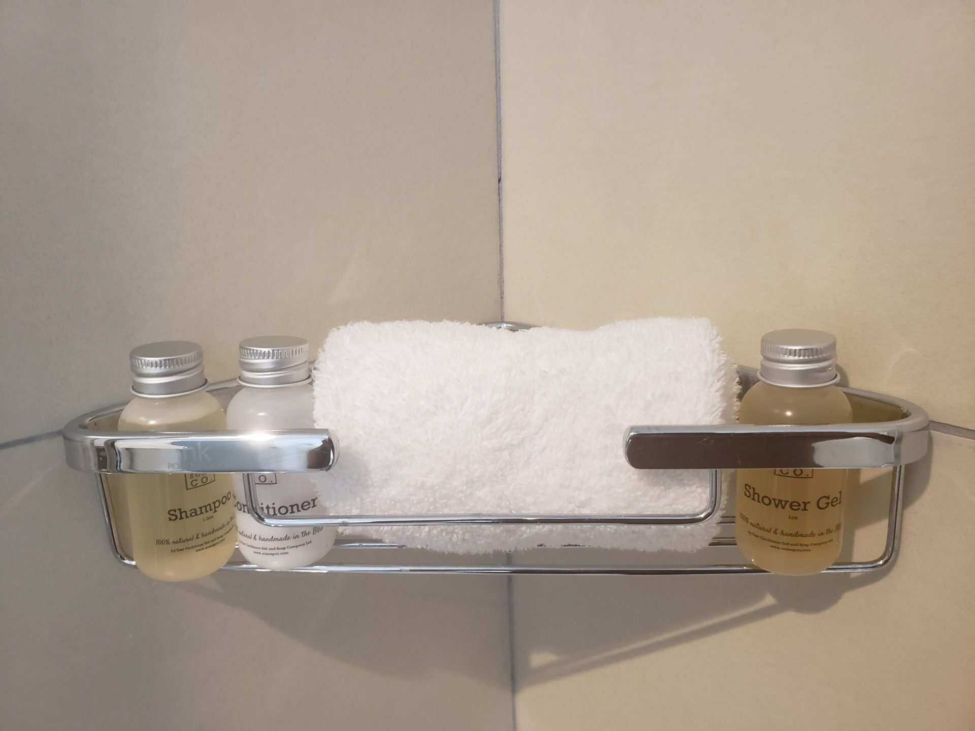 a towel and bottles of shampoo on a shelf