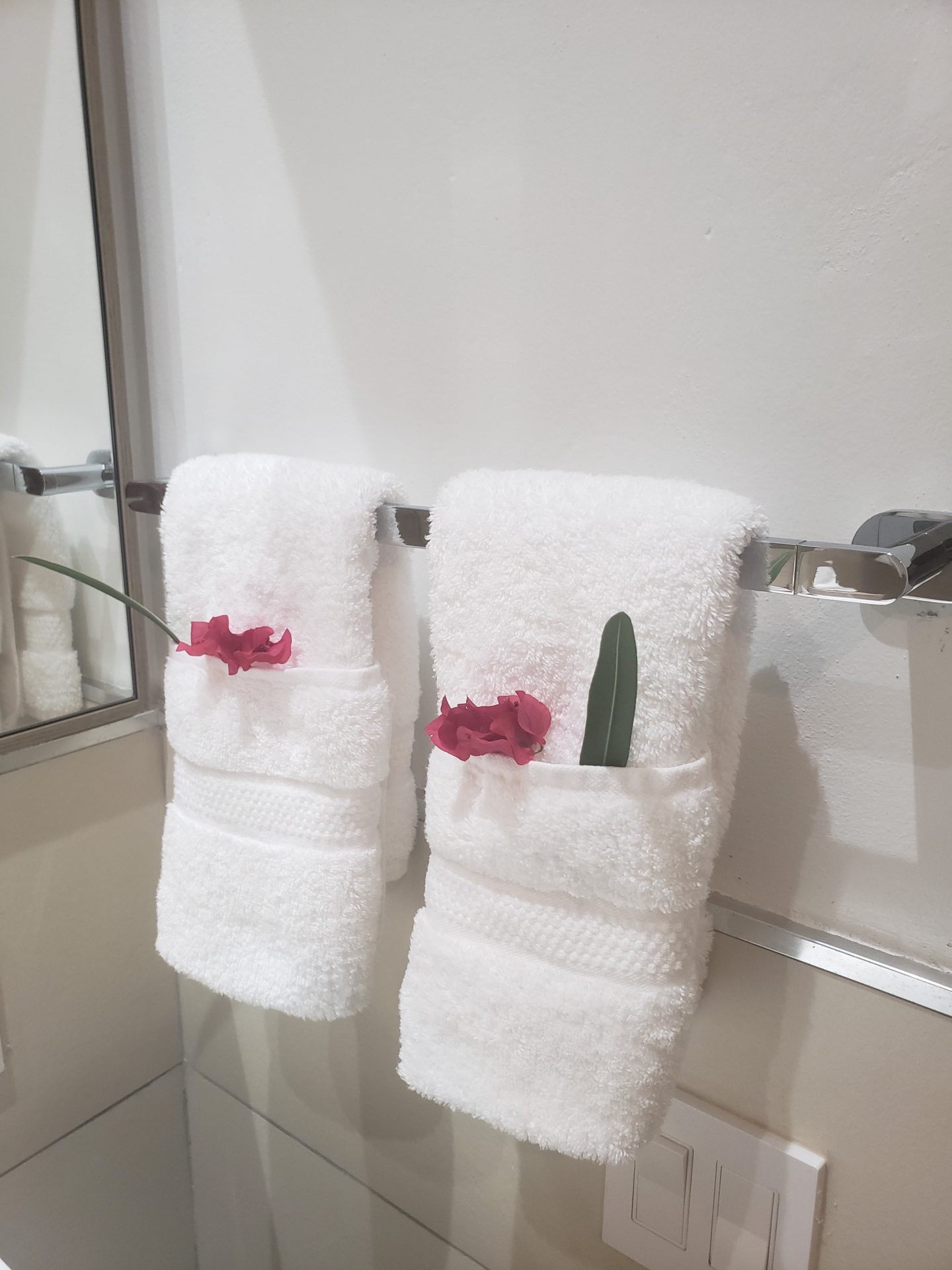 two white towels with flowers on them