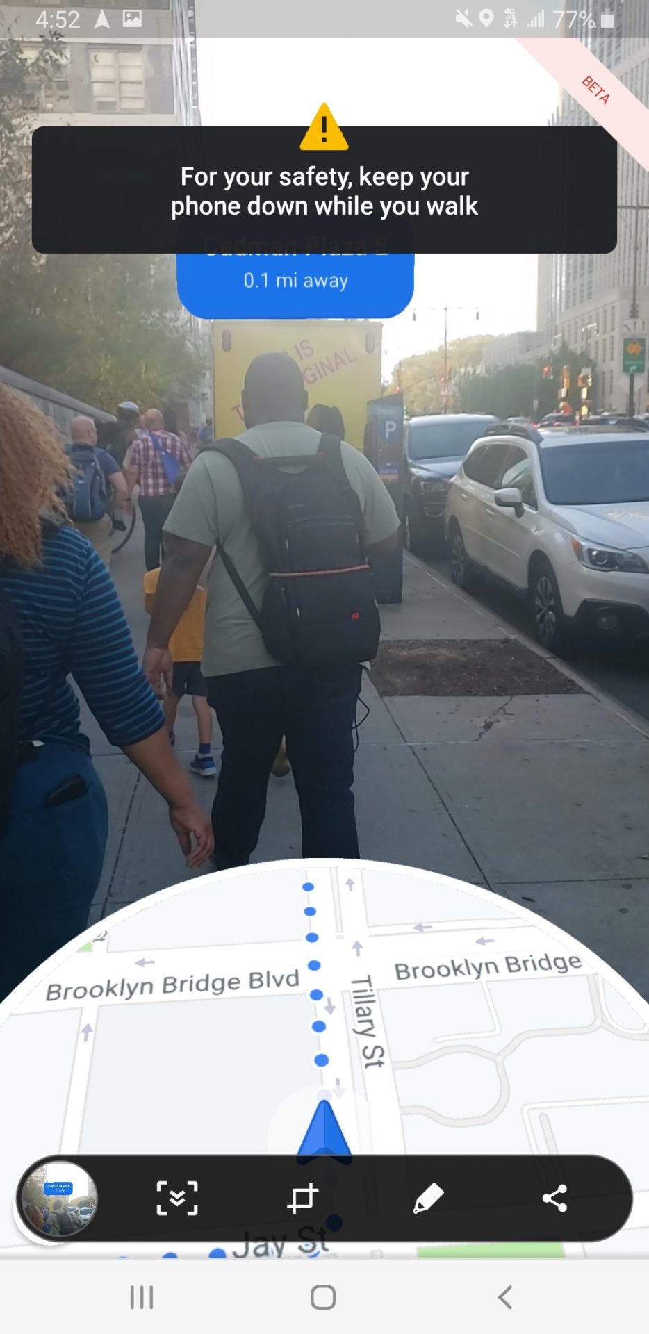 a man walking on a sidewalk with a backpack