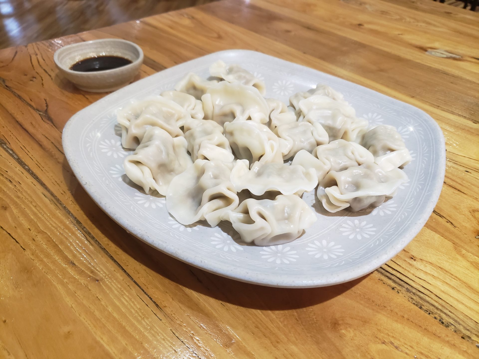 a plate of dumplings on a wooden table