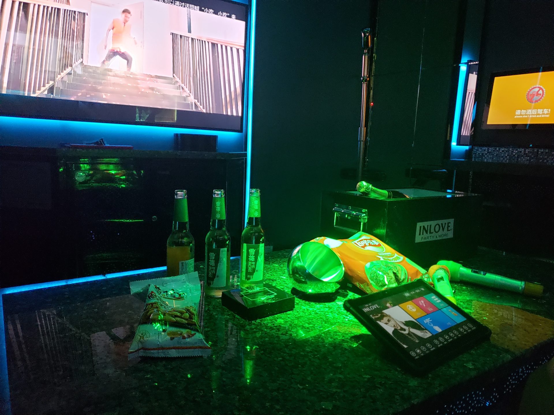 a table with a television and a television and a group of bottles