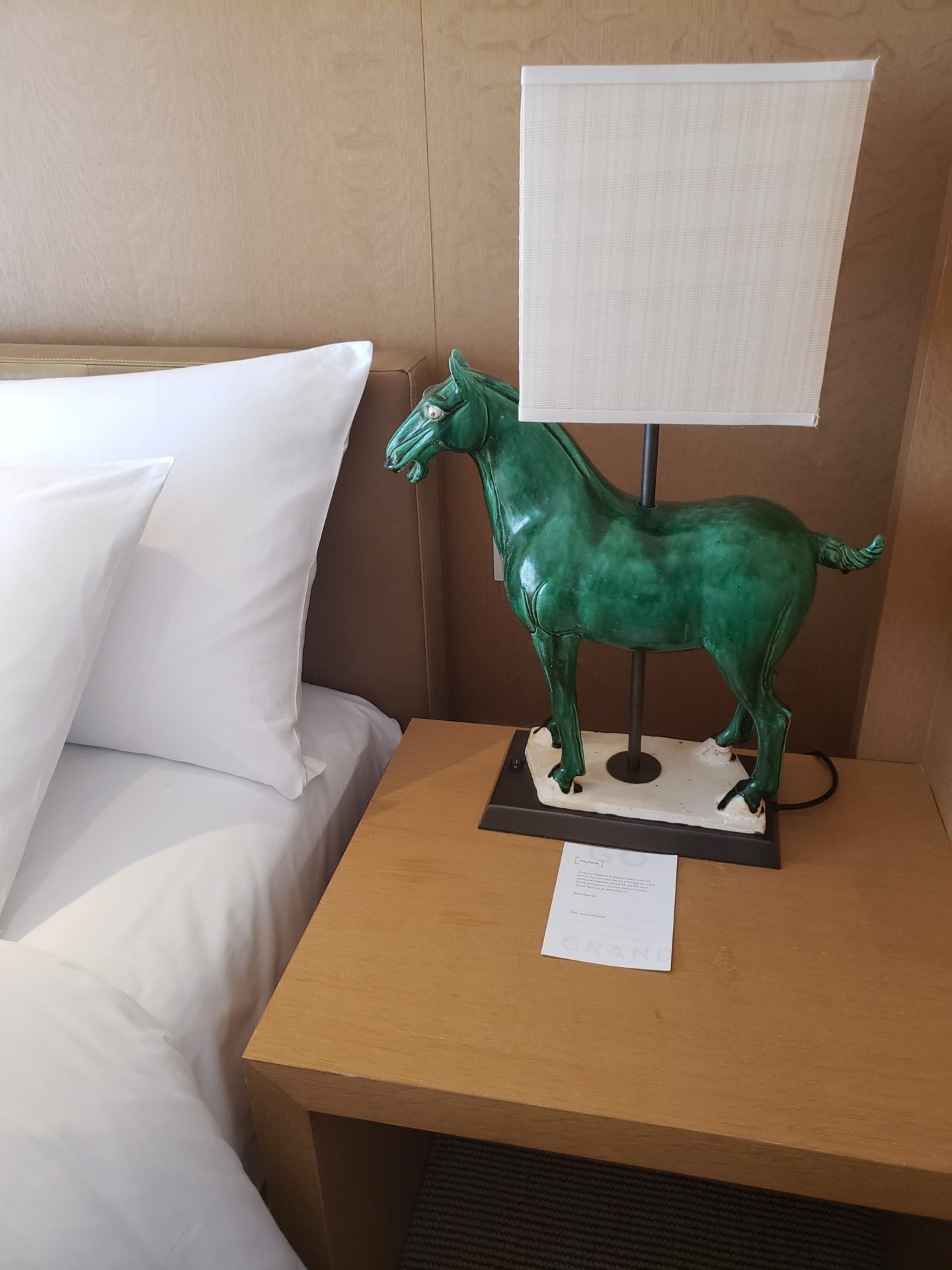 a green horse lamp on a table
