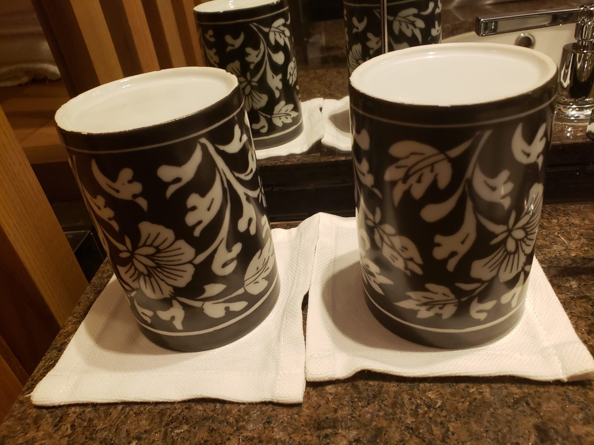 a group of black and white mugs on a napkin