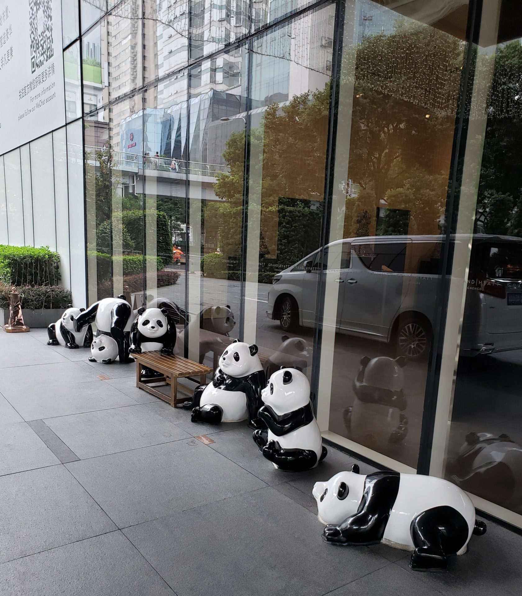 a group of panda statues outside a building