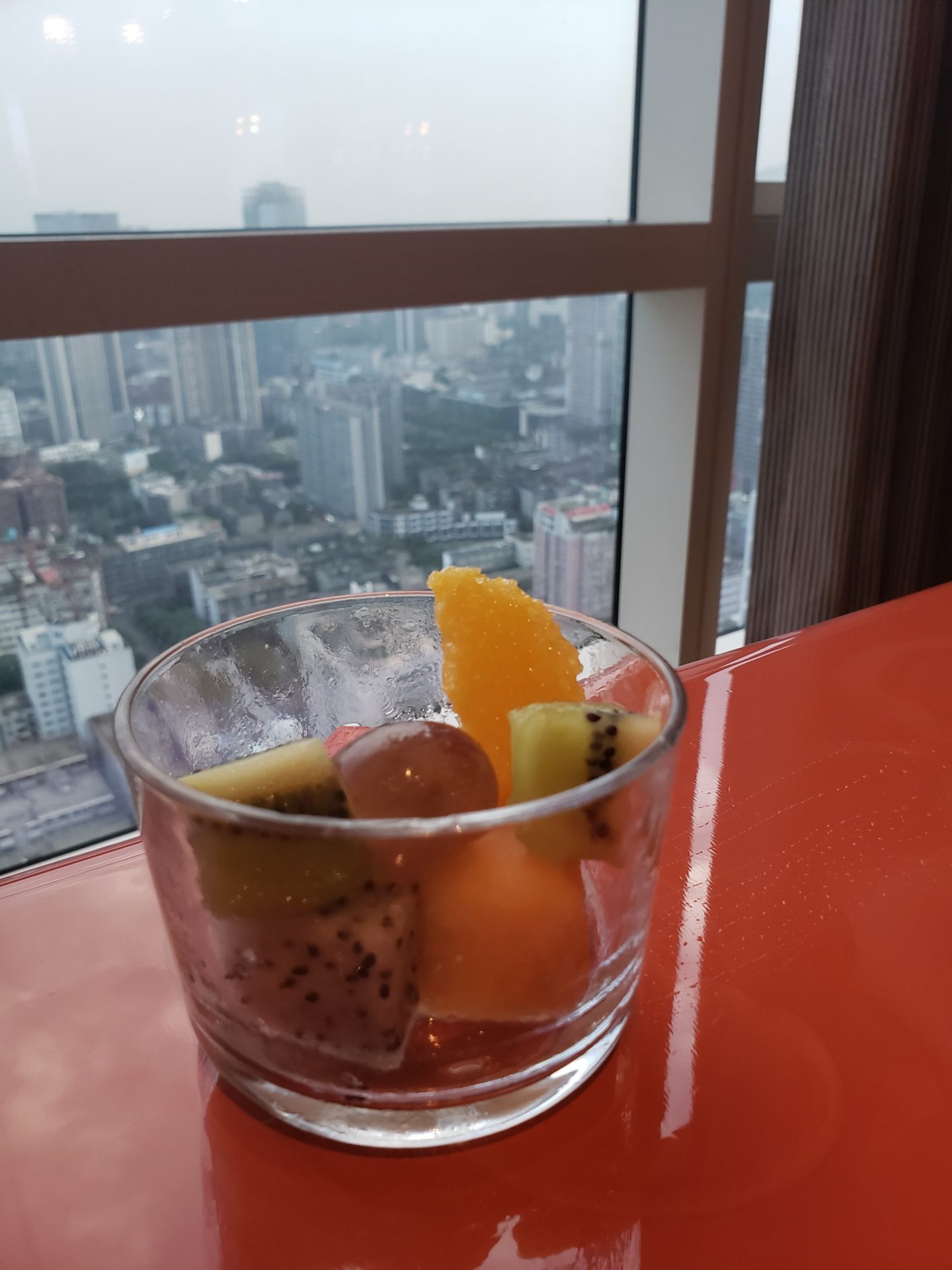 a glass of fruit on a table