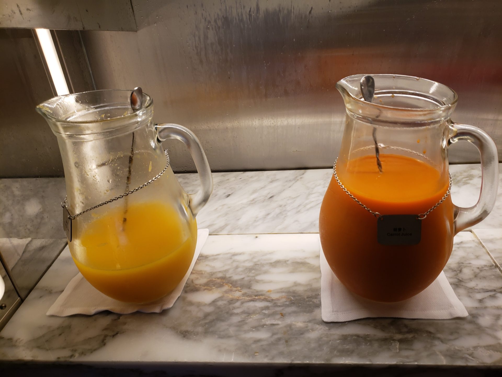 a pitcher of orange juice and a glass of orange juice